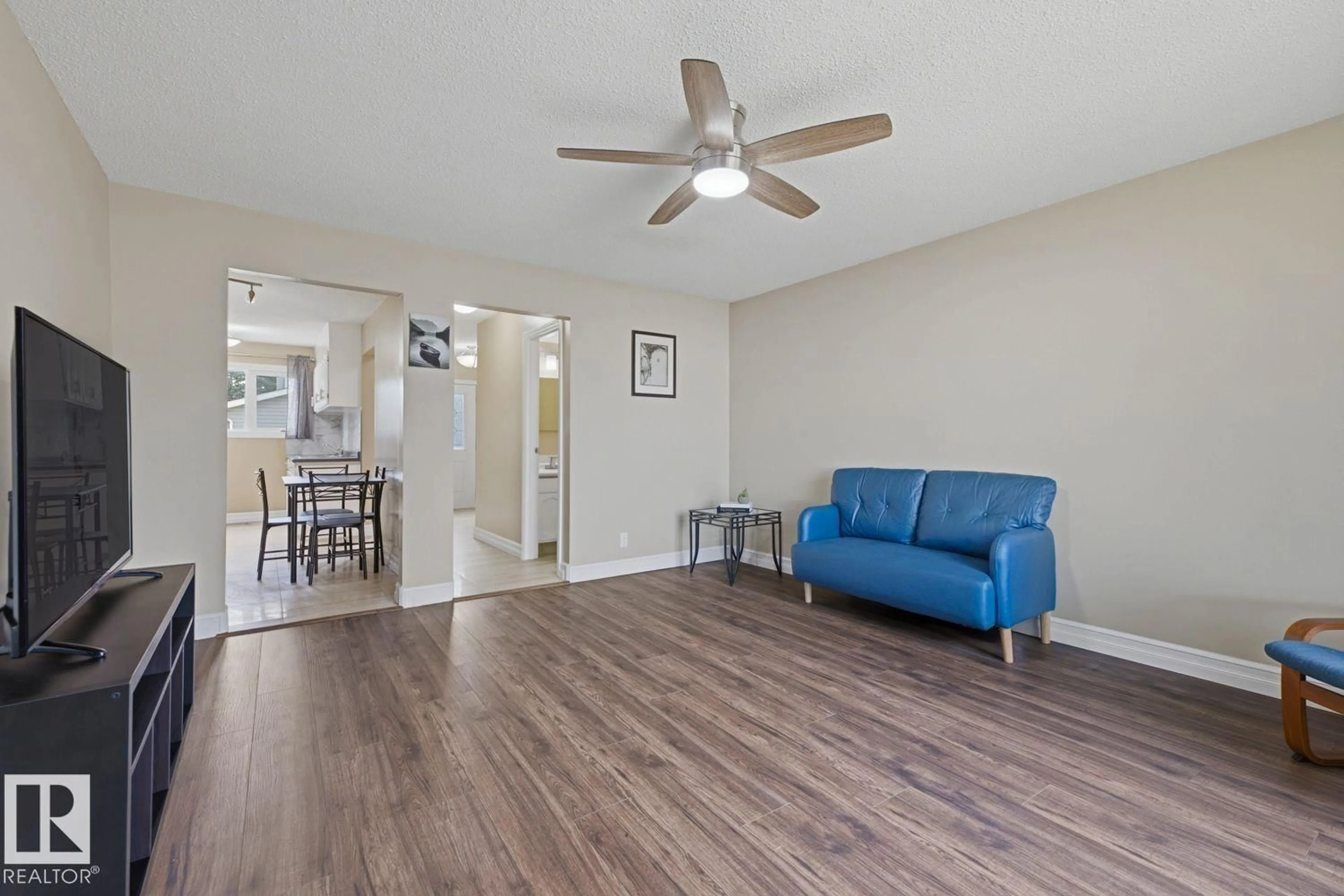 Living room with furniture, wood/laminate floor for 11317 22 AV, Edmonton Alberta T6J4V8