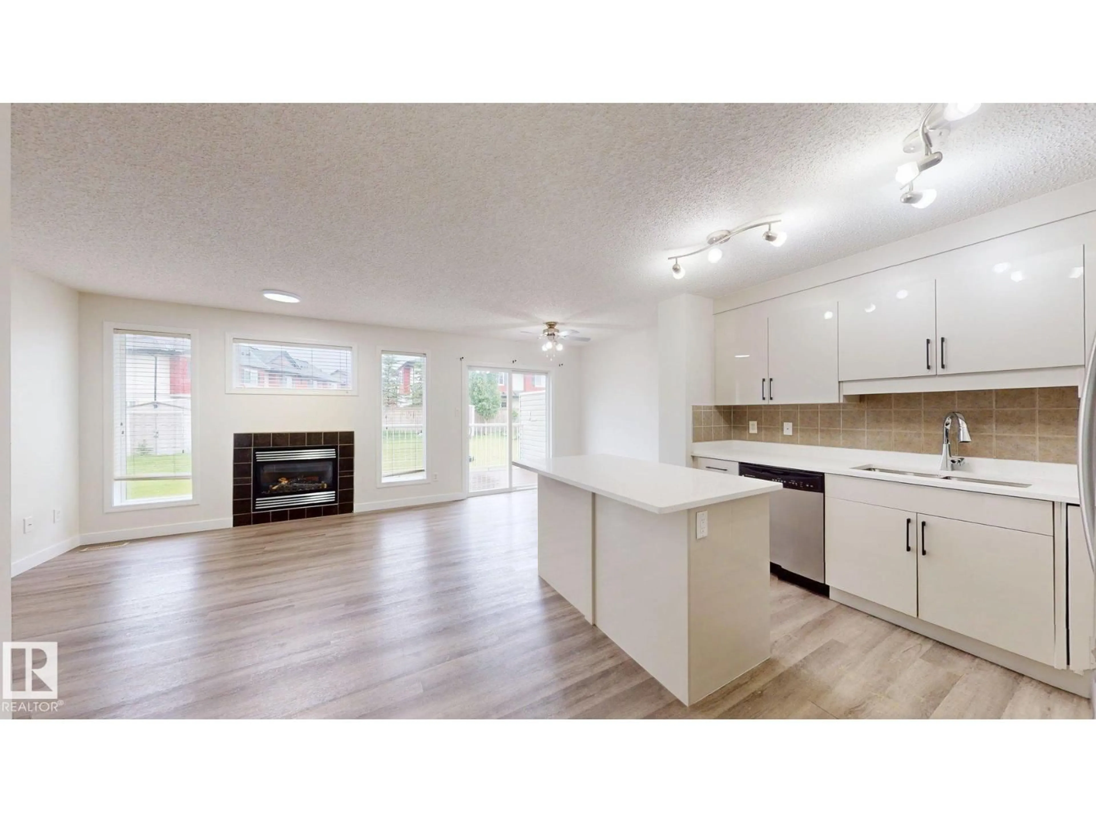 Open concept kitchen, wood/laminate floor for NW - 1150 37B AV, Edmonton Alberta T6T0E6