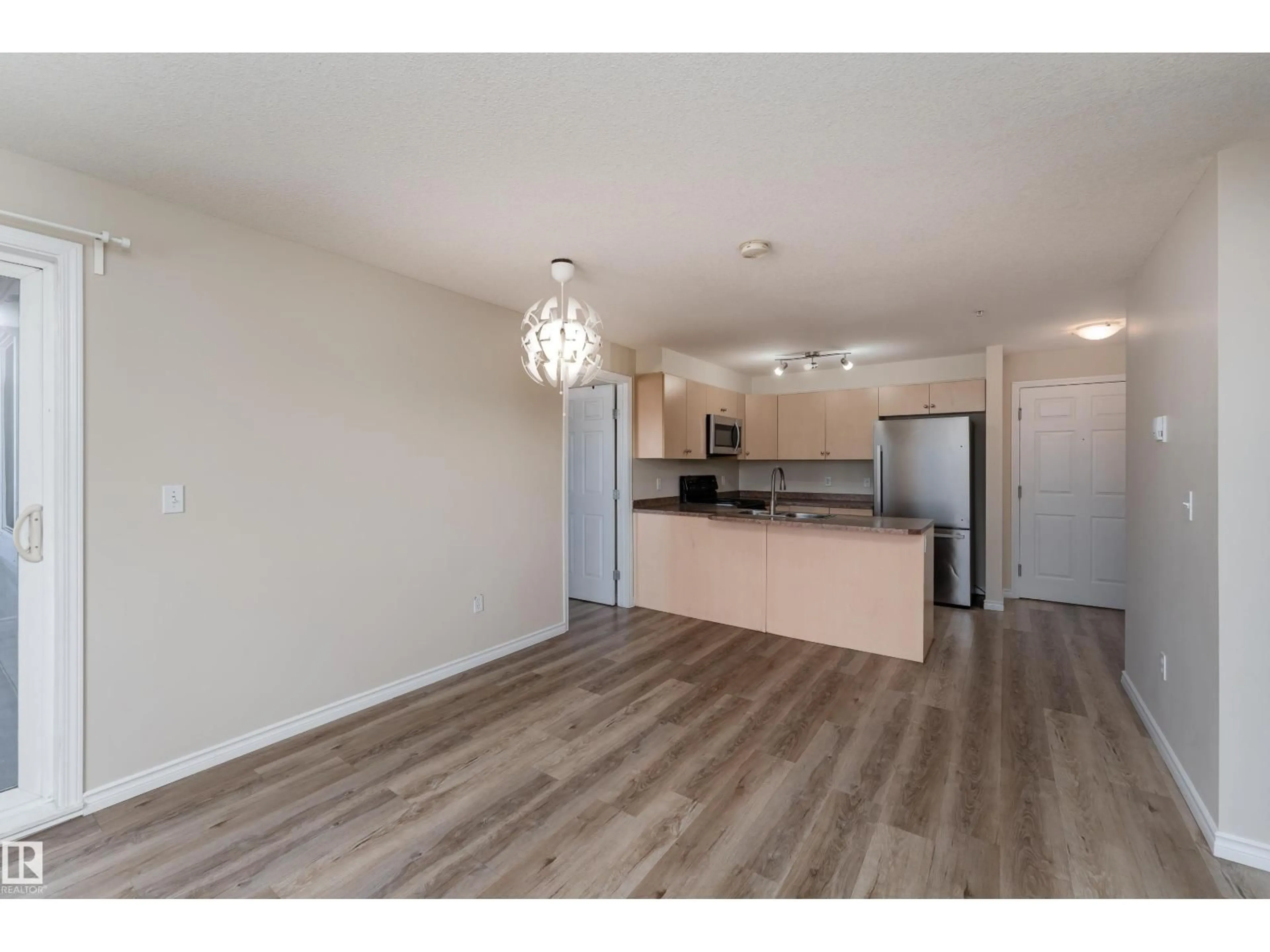 Open concept kitchen, wood/laminate floor for #214 - 4309 33 ST, Stony Plain Alberta T7Z0C4