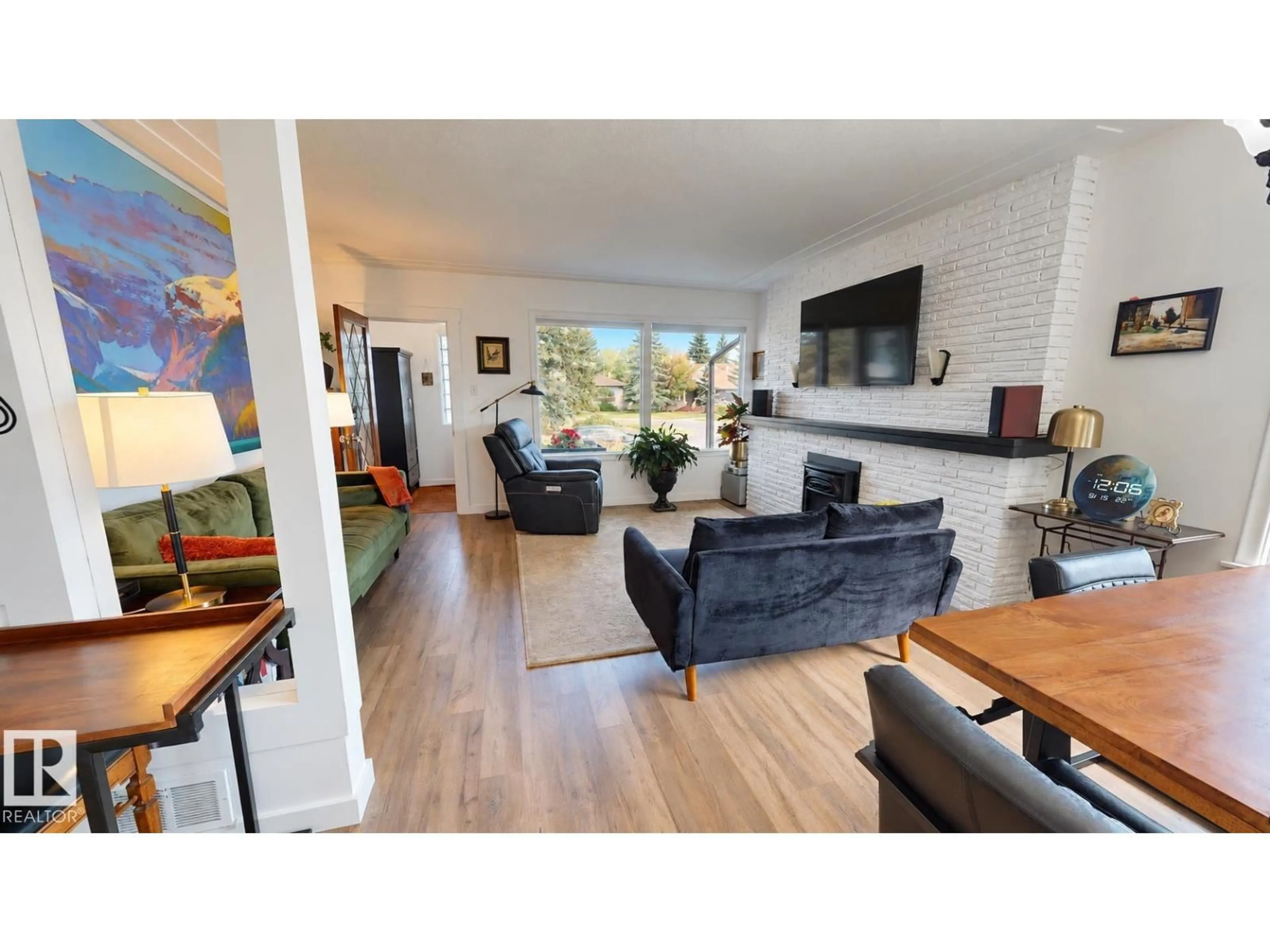 Living room with furniture, wood/laminate floor for 11403 112 AV, Edmonton Alberta T5G0H5