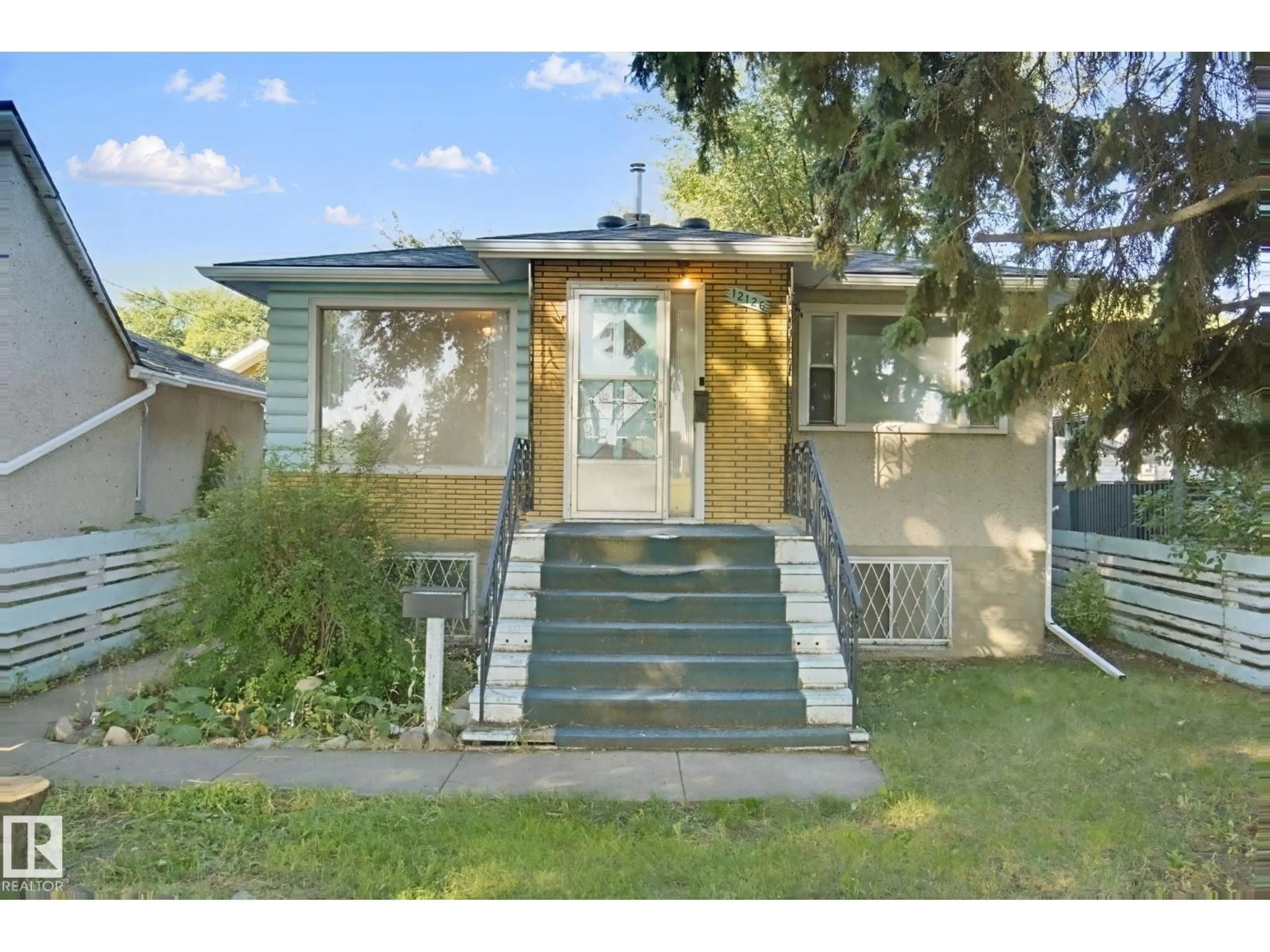 Home with vinyl exterior material, street for 12126 57 ST, Edmonton Alberta T5W3W1