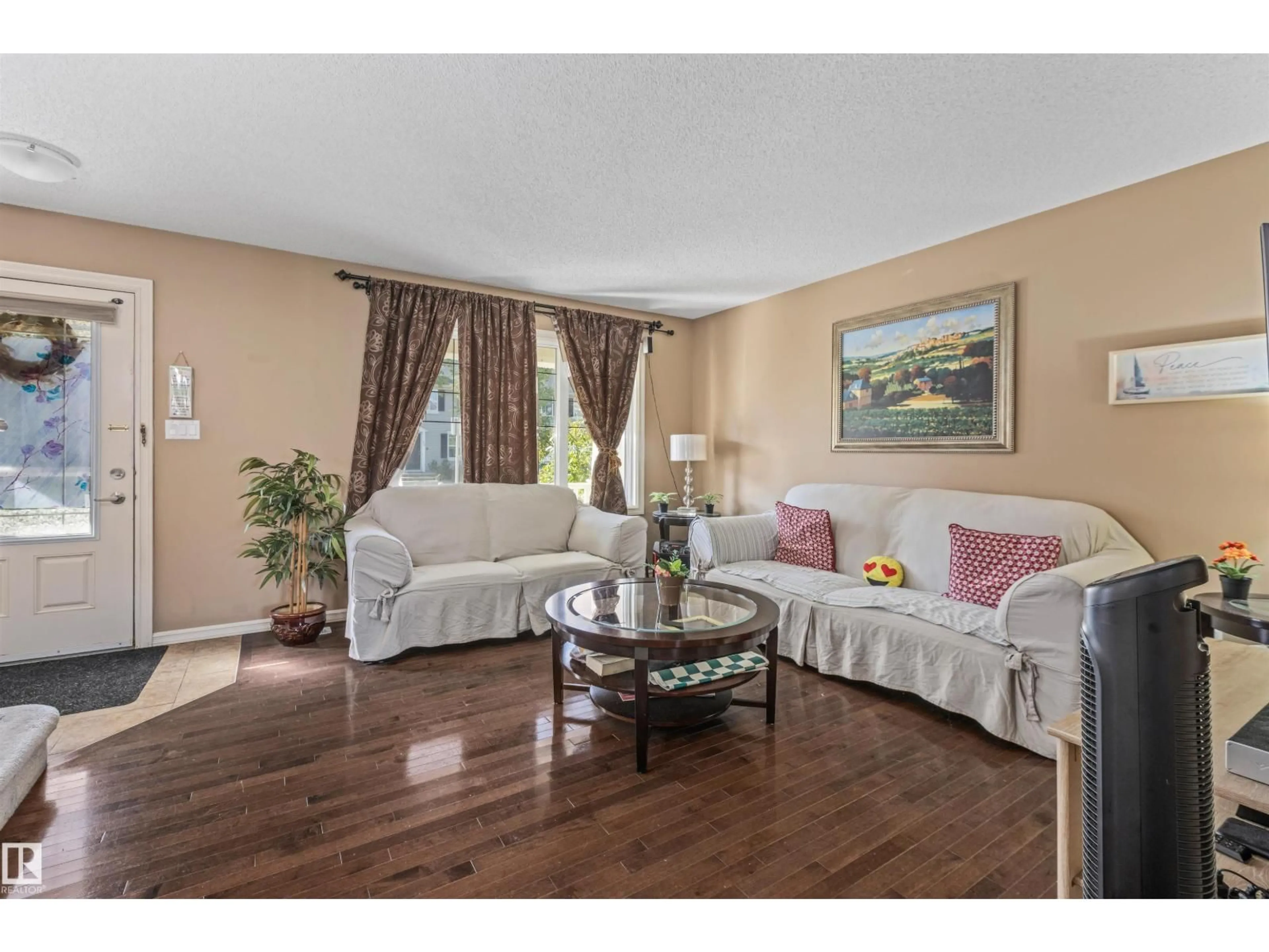 Living room with furniture, wood/laminate floor for 949 VALOUR WY, Edmonton Alberta T5E6P2