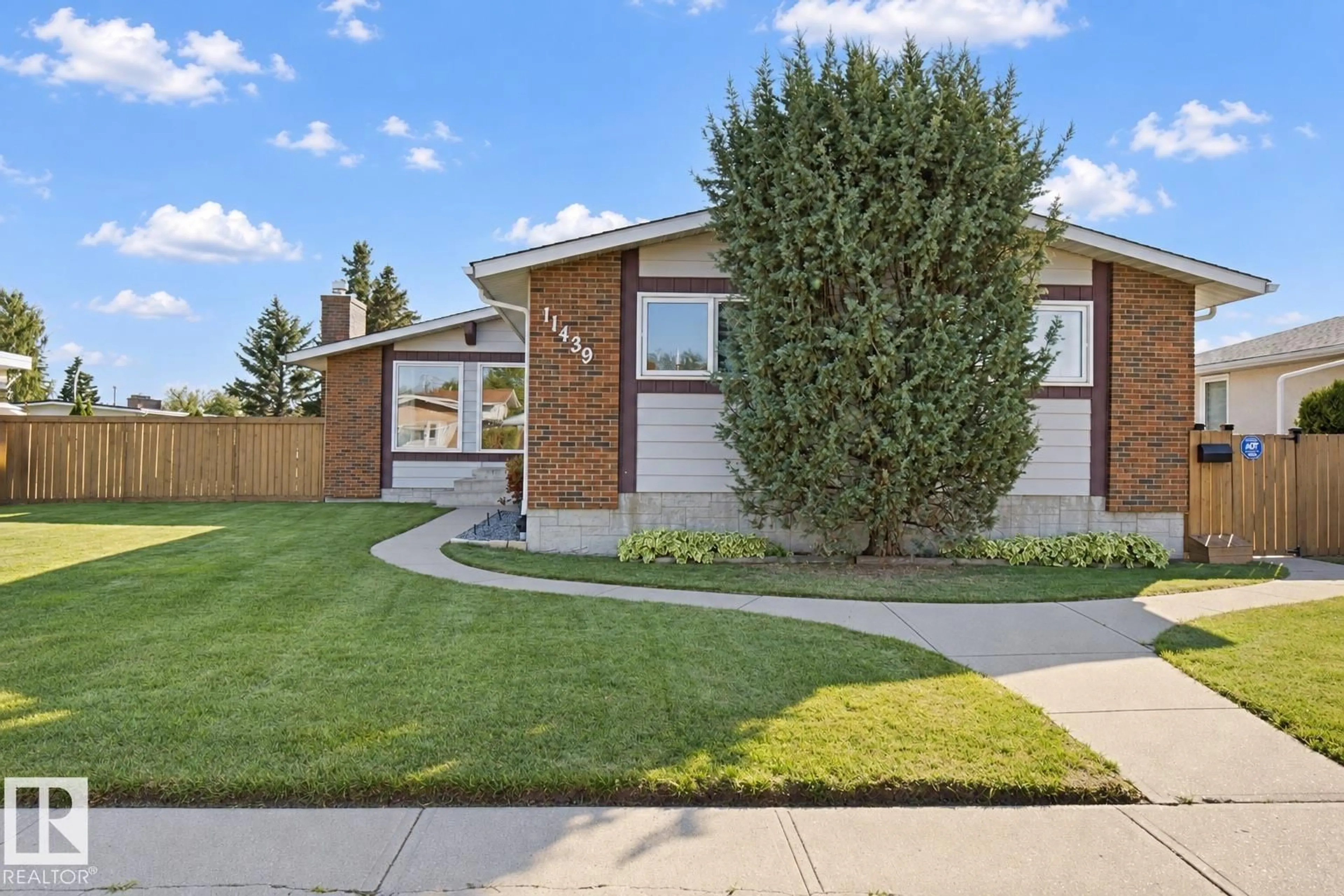 Home with brick exterior material, street for NW - 11439 144 AV, Edmonton Alberta T5X1L7