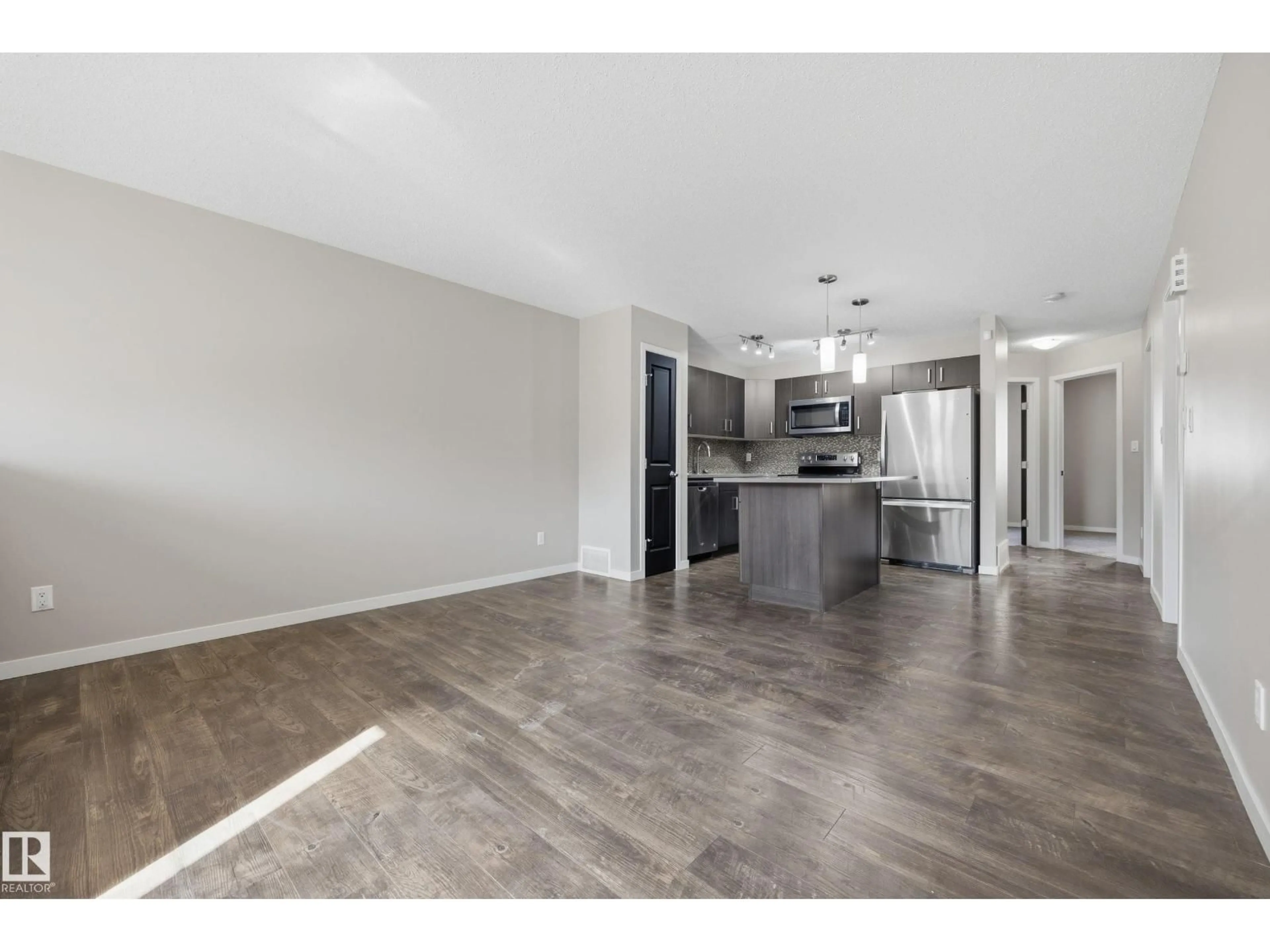 Open concept kitchen, wood/laminate floor for #43 - 3305 ORCHARDS LI, Edmonton Alberta T6X2H1