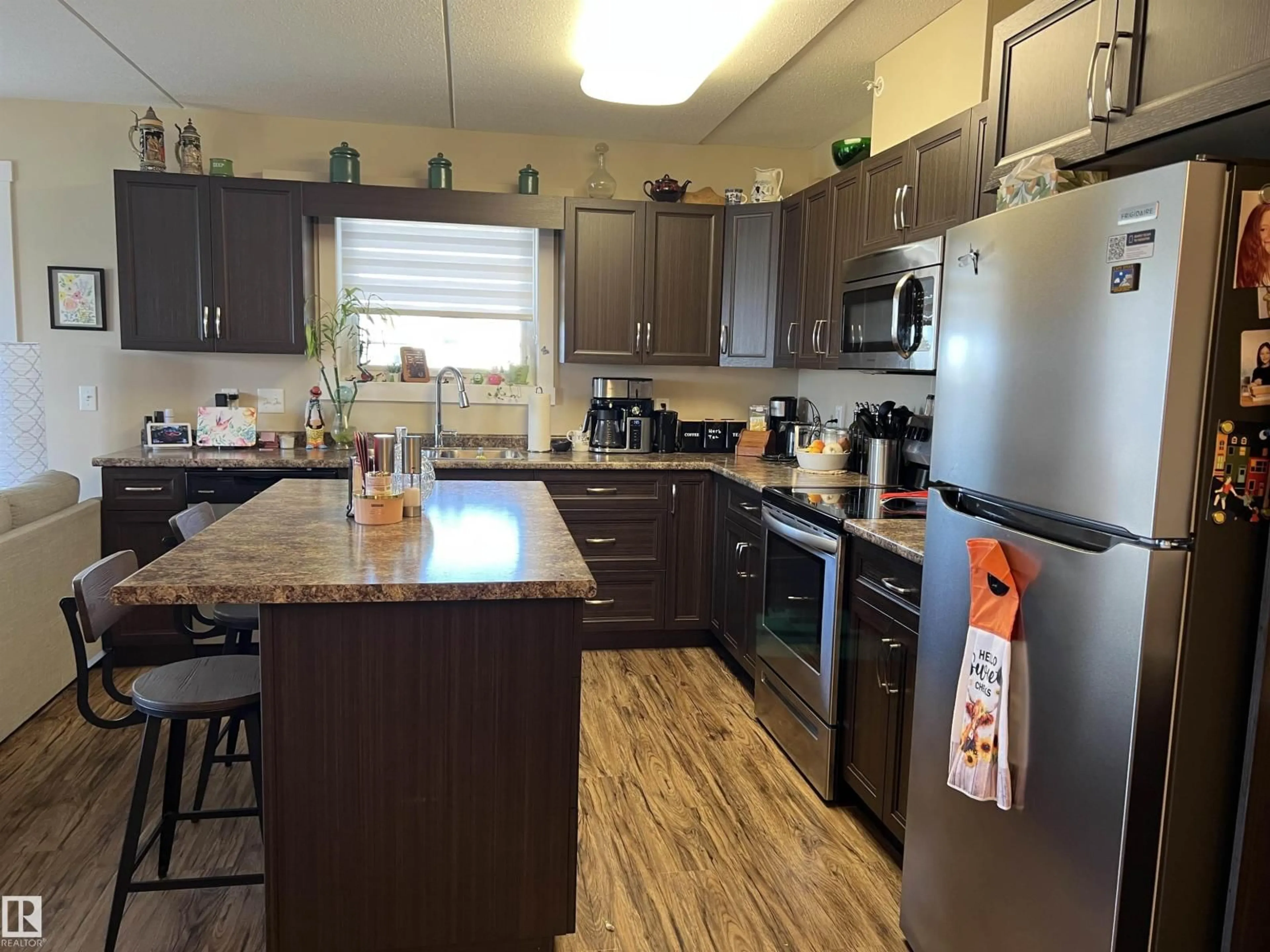 Open concept kitchen, wood/laminate floor for 307 - 4002 47 ST, Drayton Valley Alberta T7A0A2