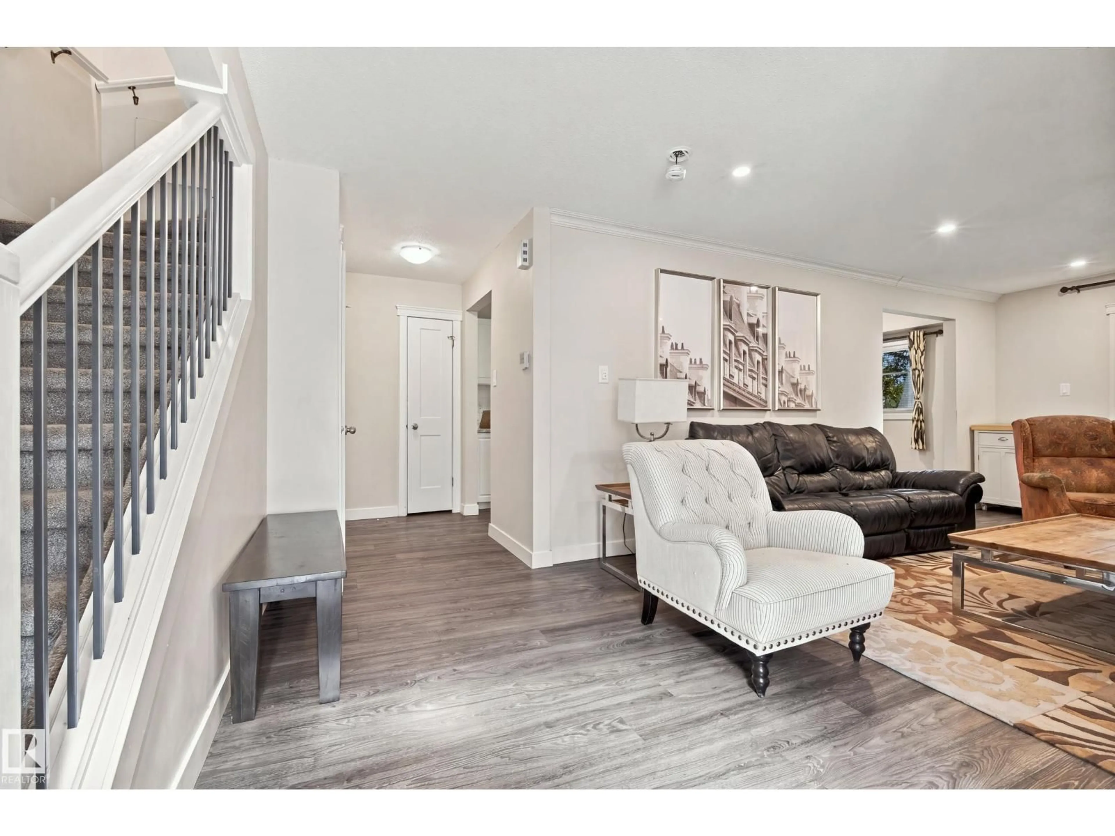 Living room with furniture, wood/laminate floor for NW - 7711-7717 75 ST, Edmonton Alberta T6C2G2