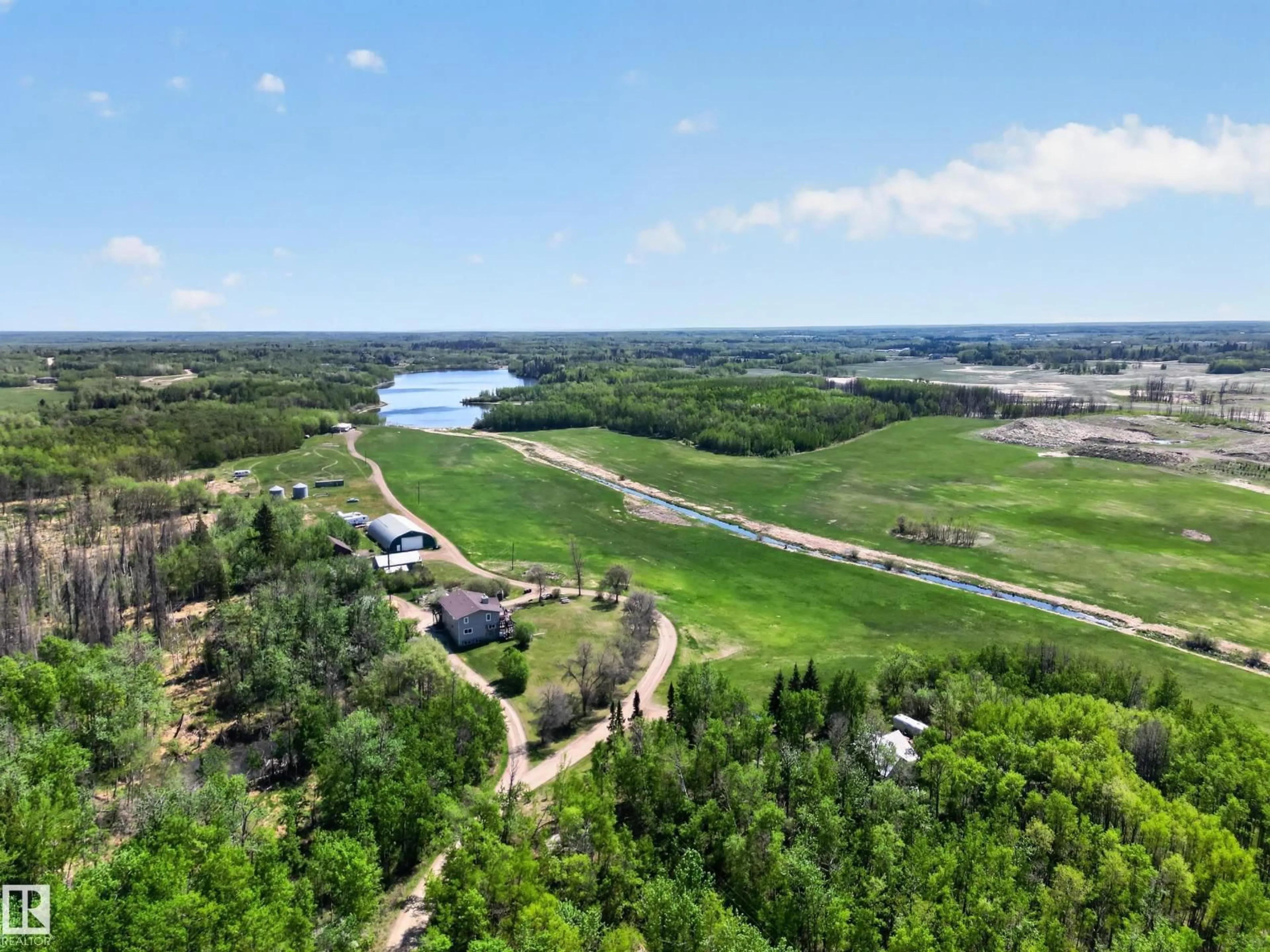 A pic from outside/outdoor area/front of a property/back of a property/a pic from drone, water/lake/river/ocean view for 52073 HWY 21, Rural Strathcona County Alberta T8B1J4
