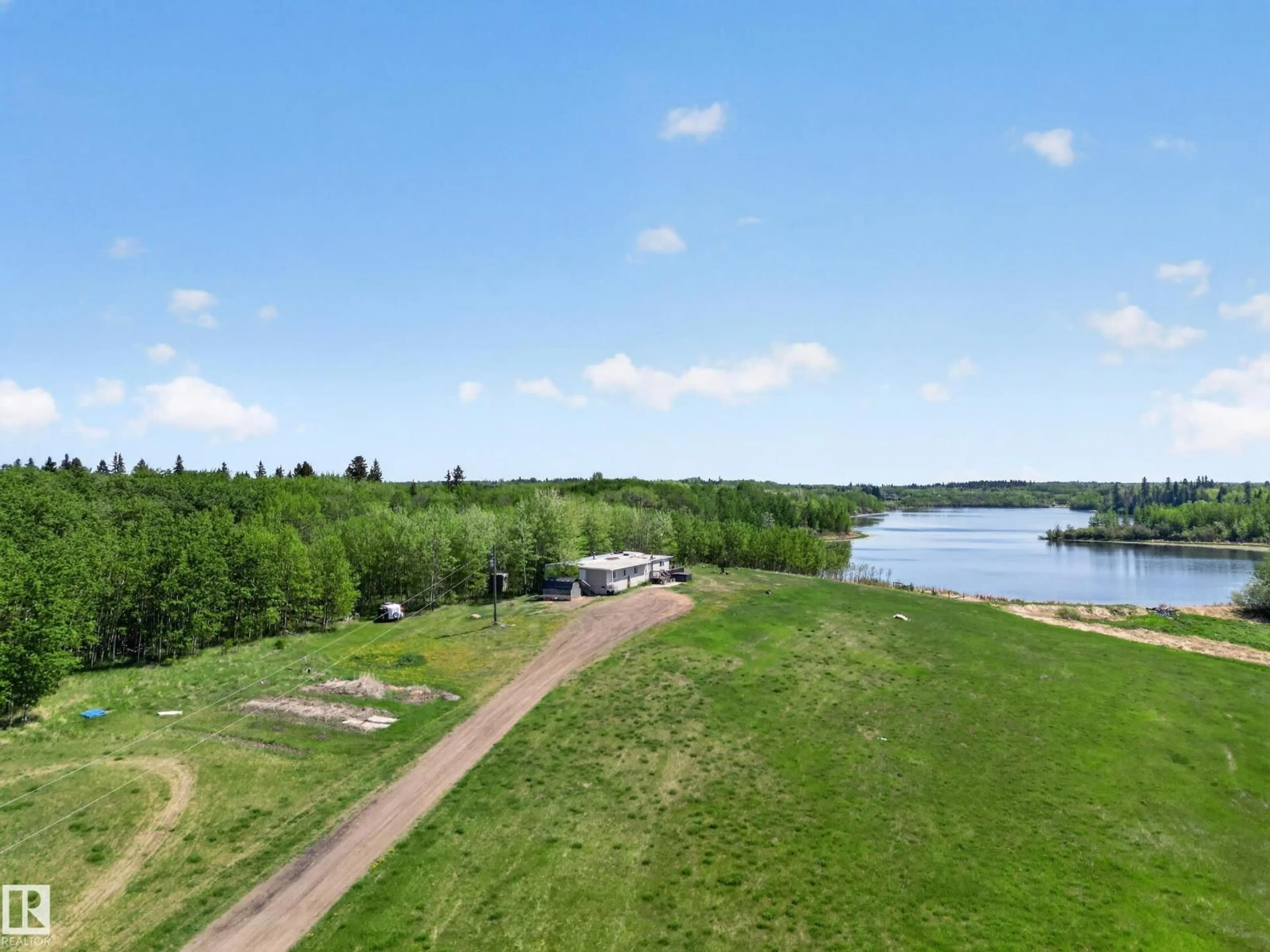 A pic from outside/outdoor area/front of a property/back of a property/a pic from drone, water/lake/river/ocean view for 52073 HWY 21, Rural Strathcona County Alberta T8B1J4