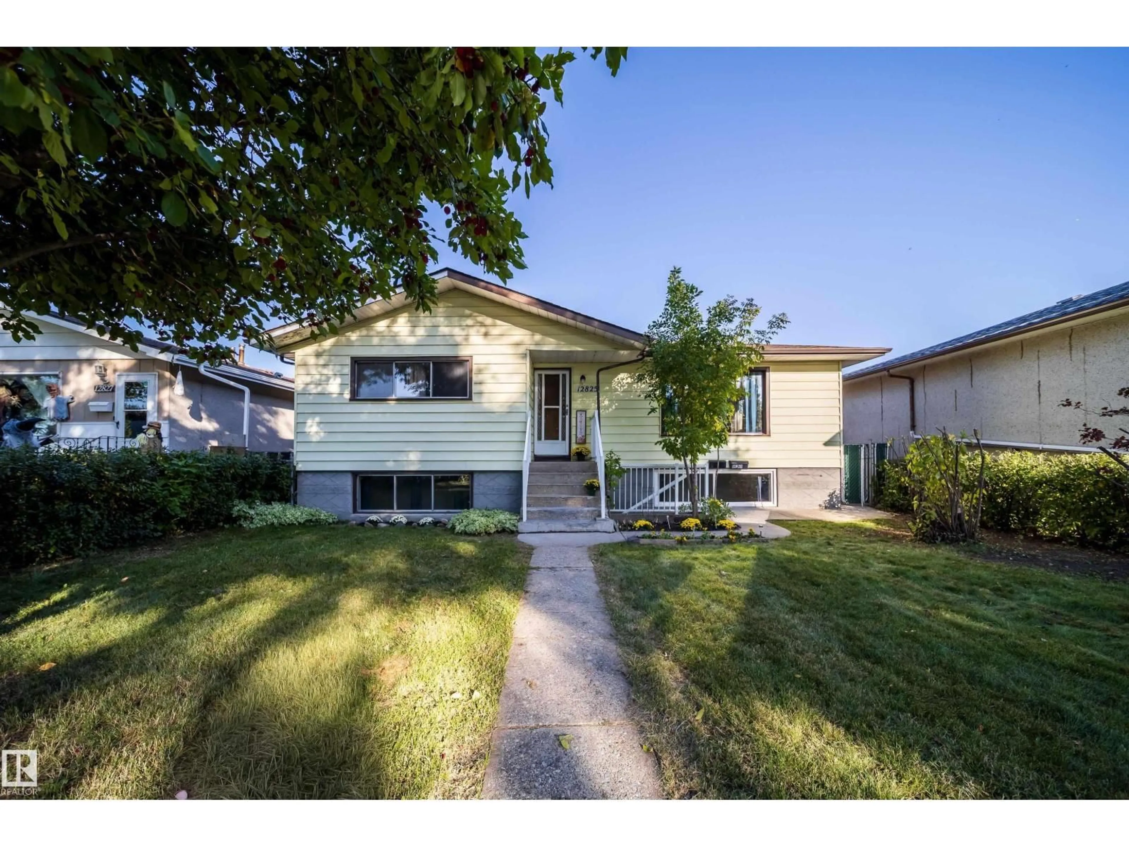 Home with vinyl exterior material, street for 12825 102 ST, Edmonton Alberta T5E4J2