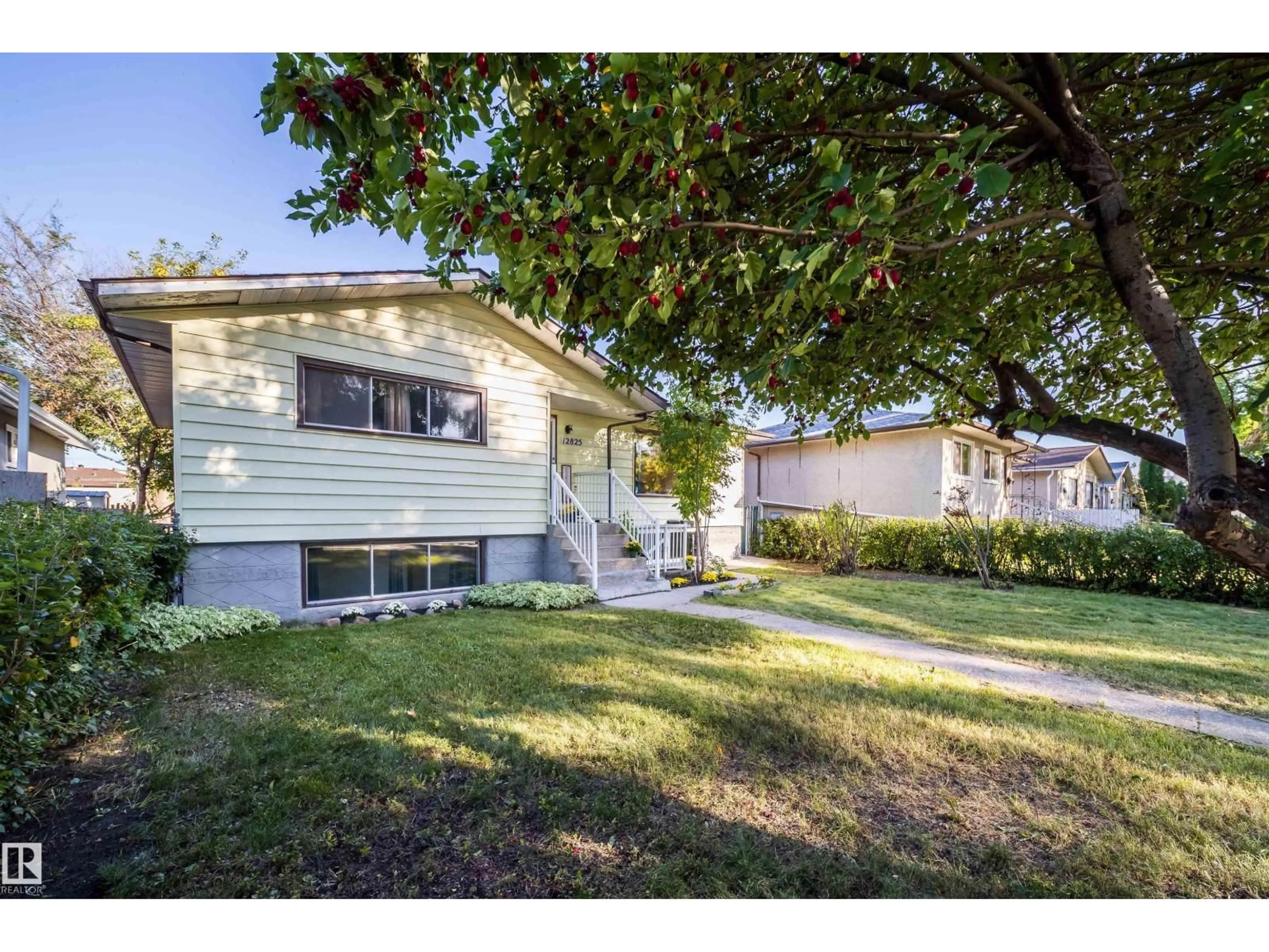 Home with vinyl exterior material, street for 12825 102 ST, Edmonton Alberta T5E4J2