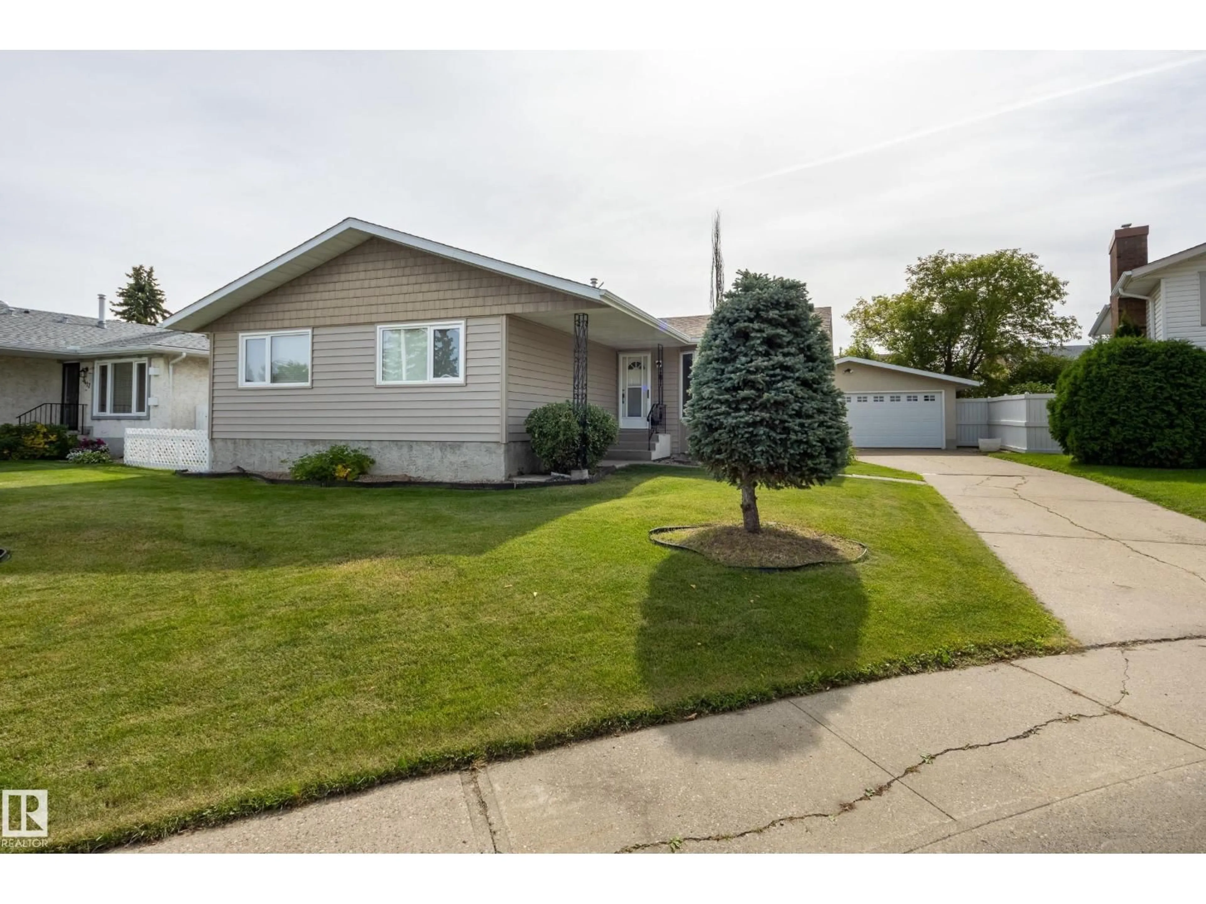 Home with vinyl exterior material, street for 3421 135A AV, Edmonton Alberta T5A2V8