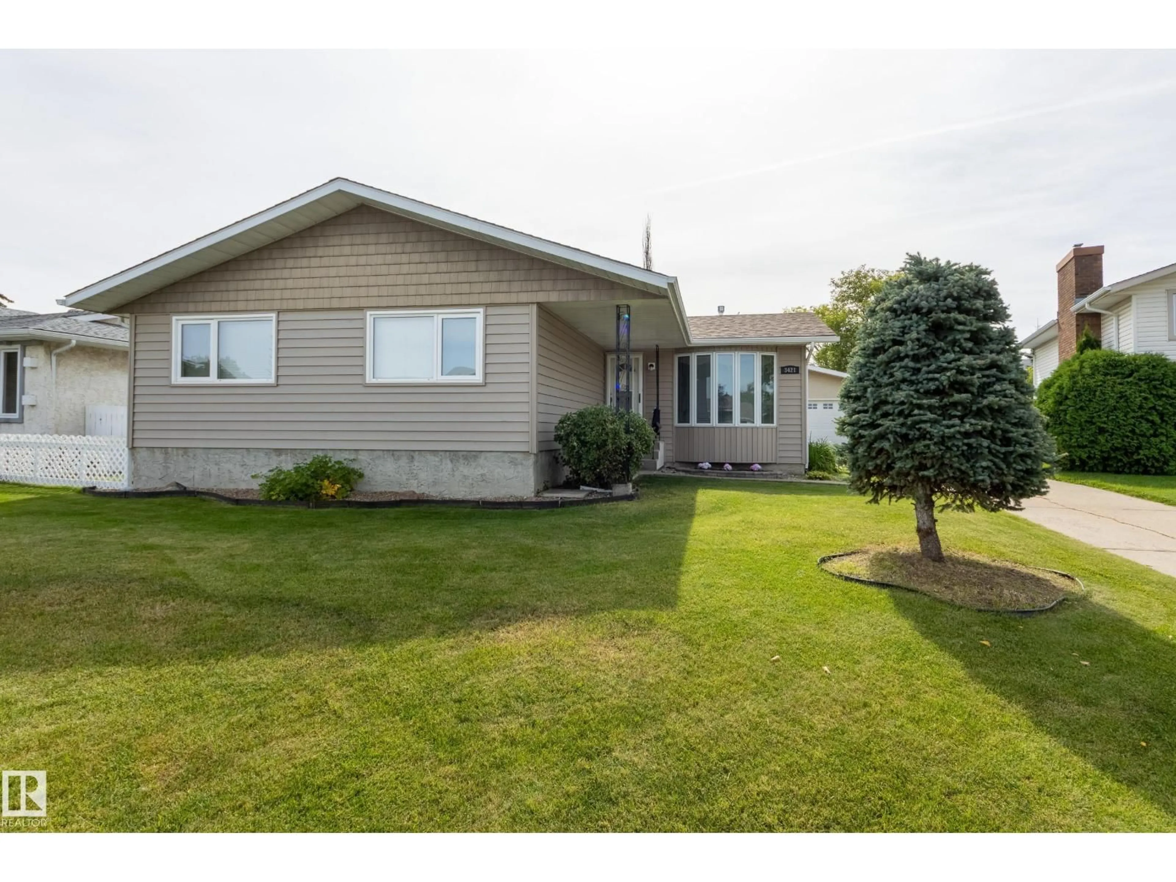 Home with vinyl exterior material, street for 3421 135A AV, Edmonton Alberta T5A2V8