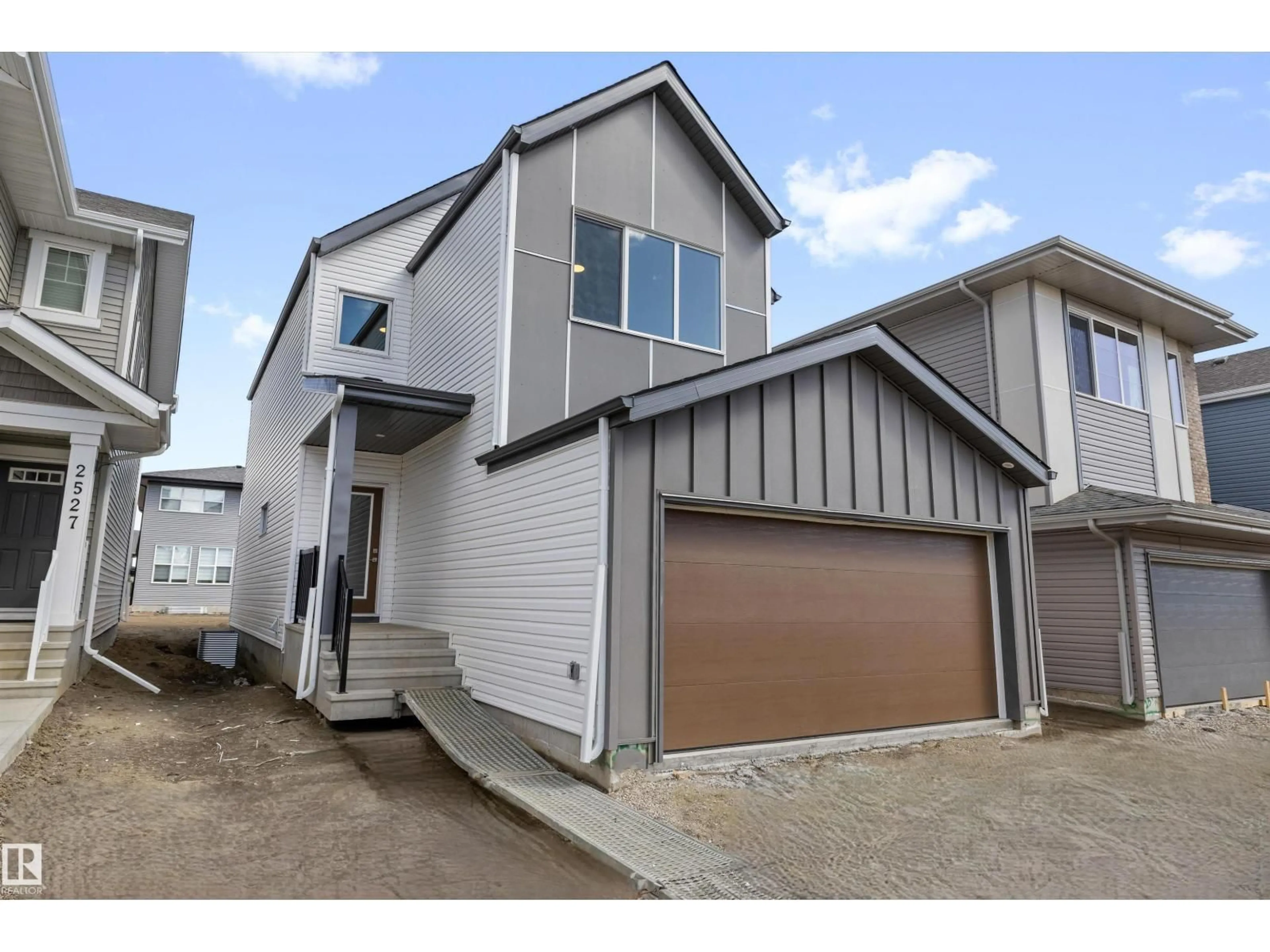 Home with vinyl exterior material, street for NW - 2523 210 ST, Edmonton Alberta T6M2M7
