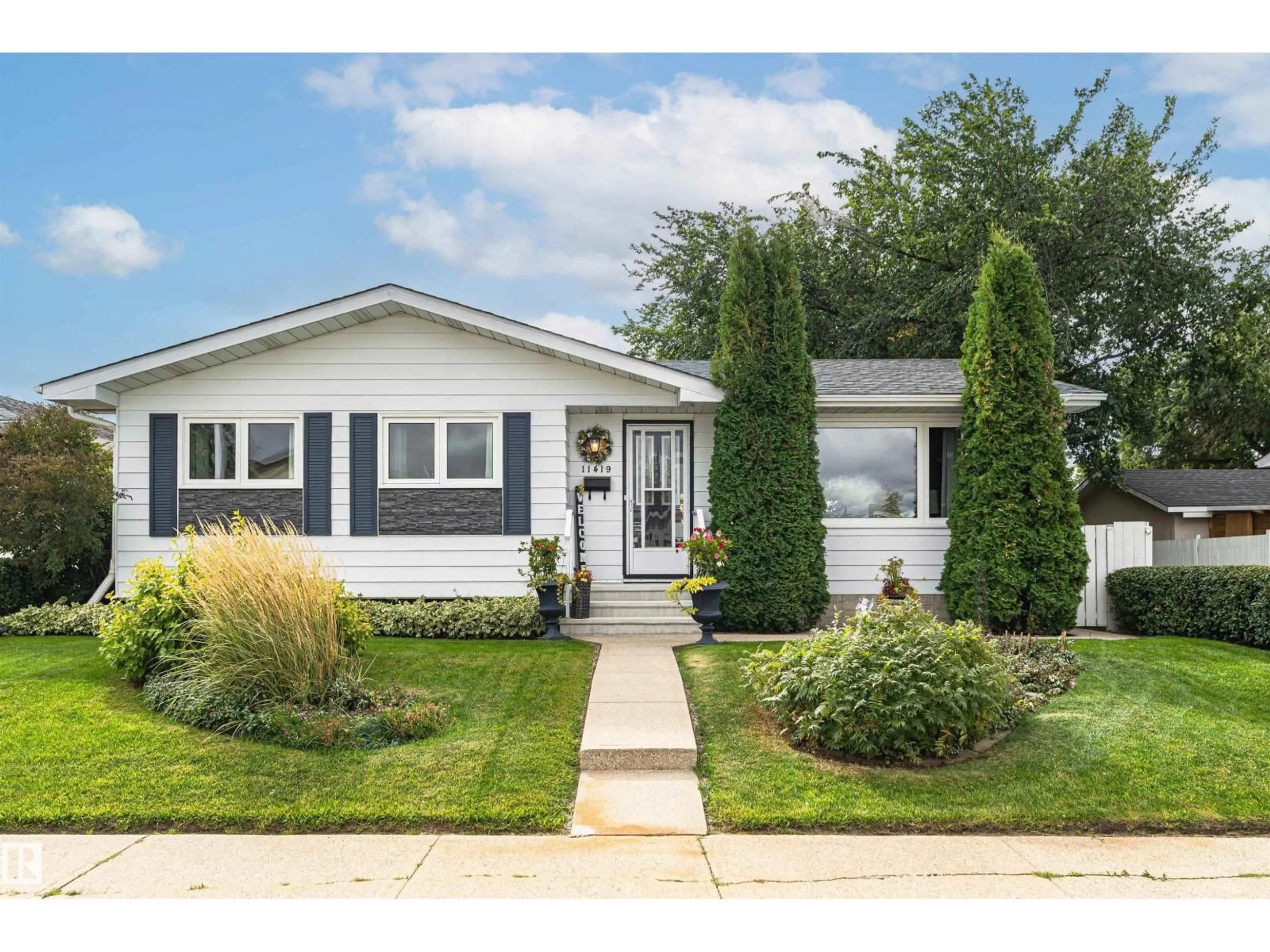 Home with vinyl exterior material, street for 11419 149 AV, Edmonton Alberta T5X1B9