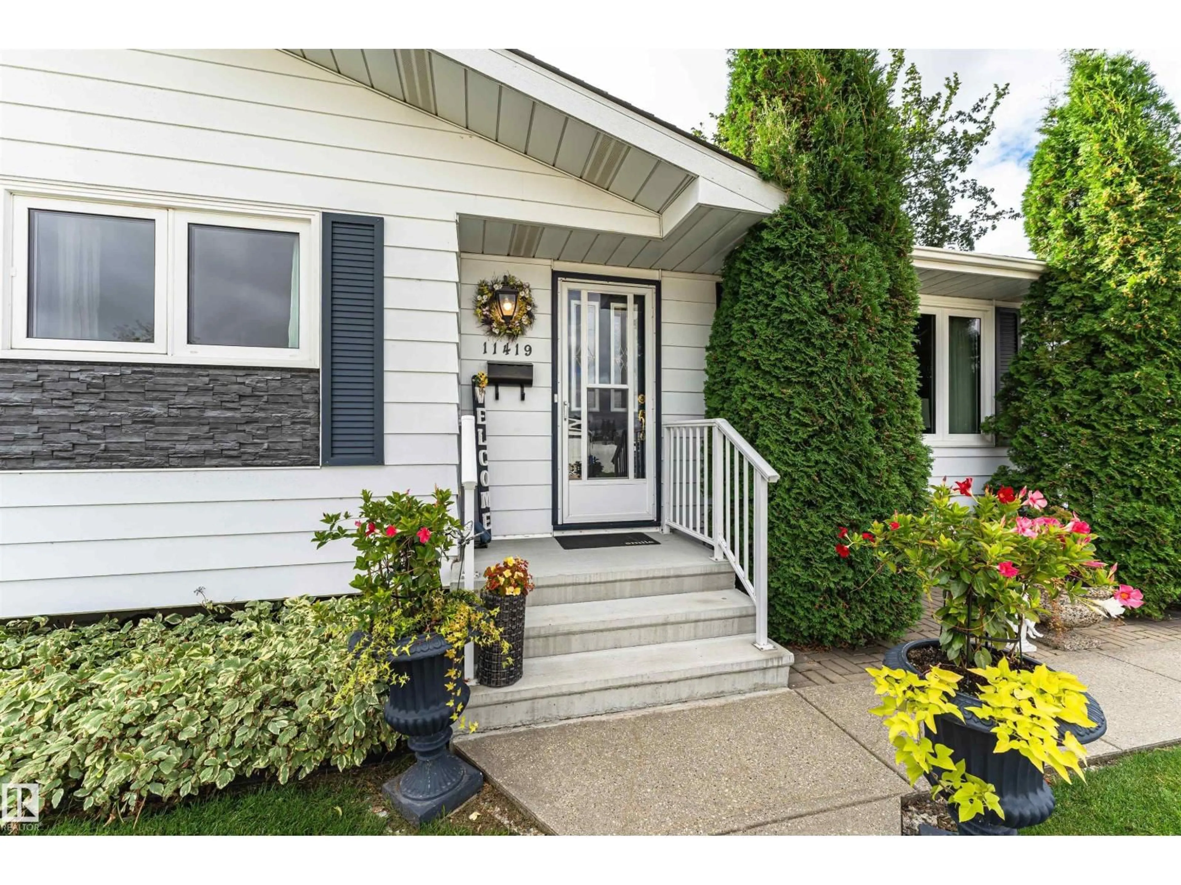 Home with vinyl exterior material, street for 11419 149 AV, Edmonton Alberta T5X1B9