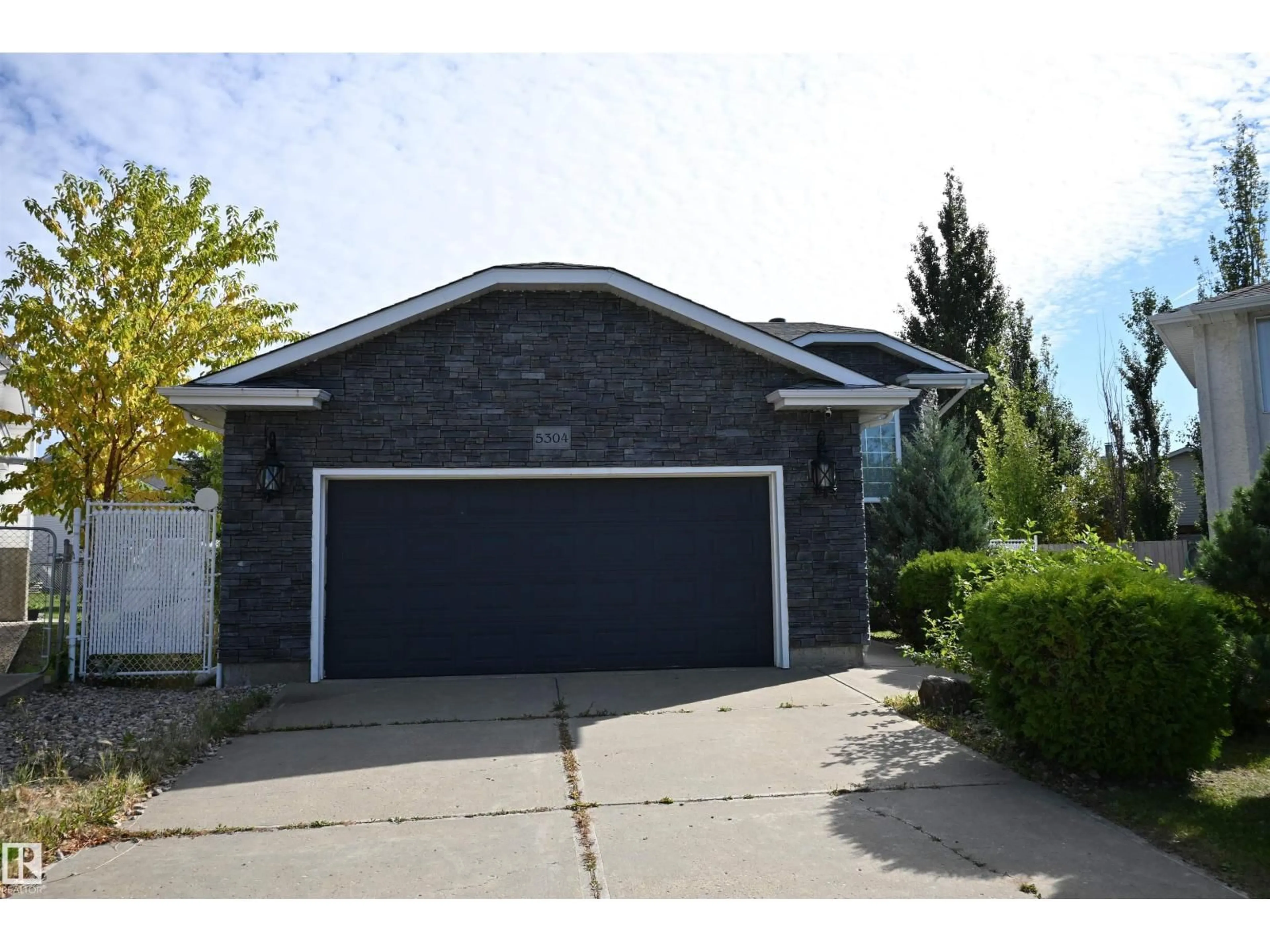 Home with vinyl exterior material, street for NW - 5304 155 AV, Edmonton Alberta T5Y2S6