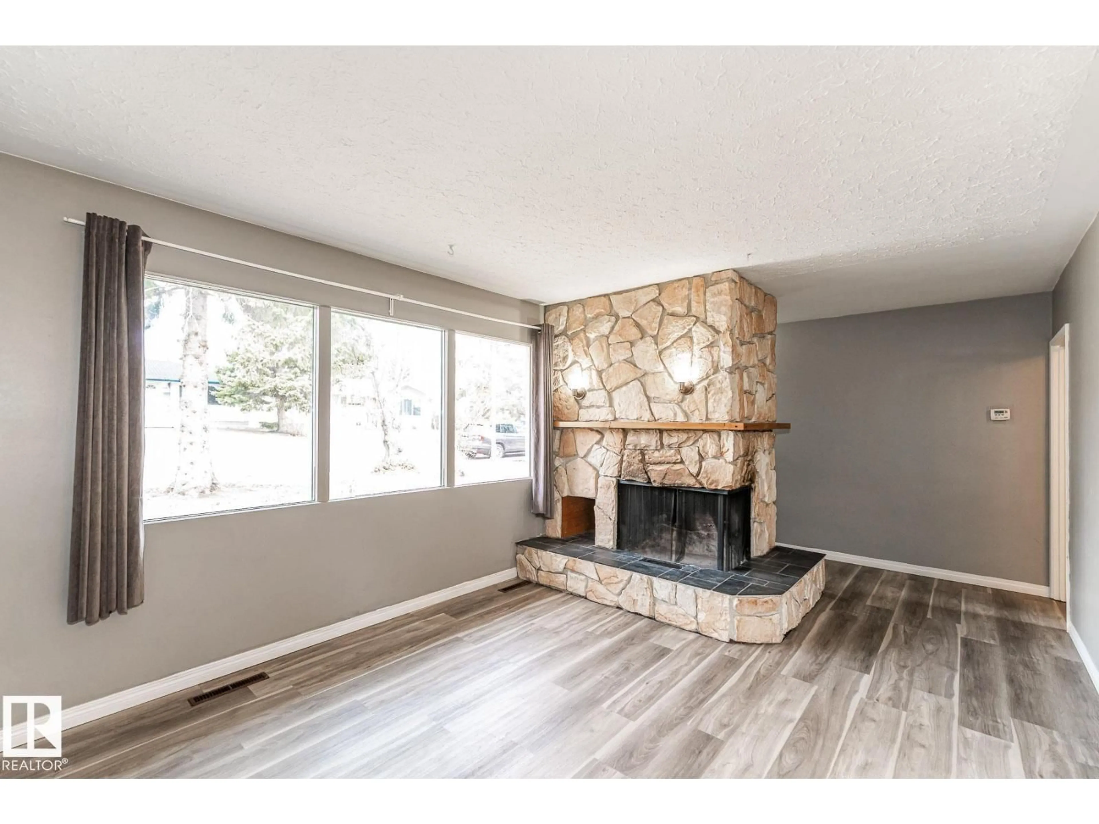 Living room with furniture, wood/laminate floor for NW - 10551 53 AV, Edmonton Alberta T6H0R6
