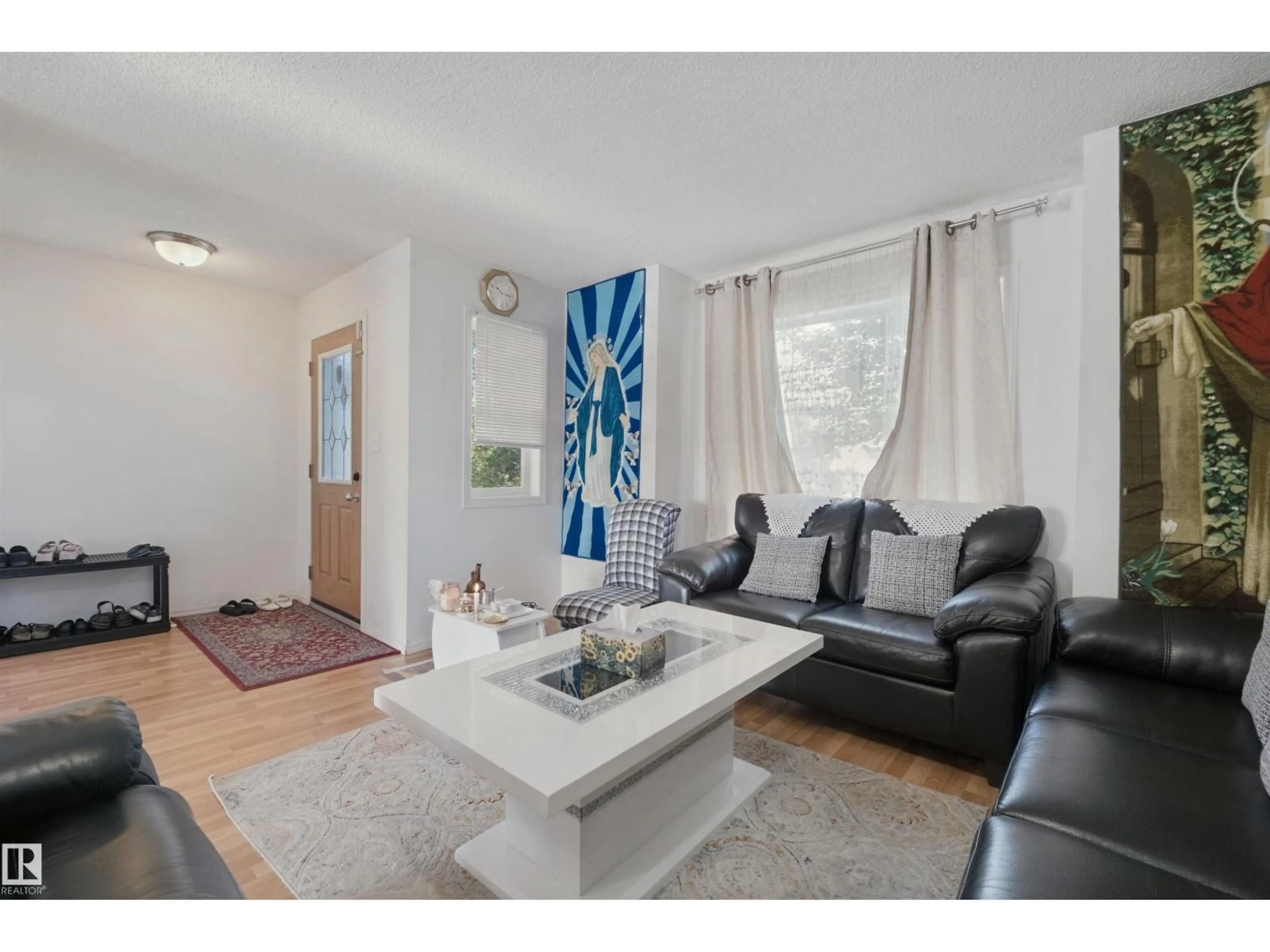 Living room with furniture, wood/laminate floor for 15911 38 ST, Edmonton Alberta T5Y3E9