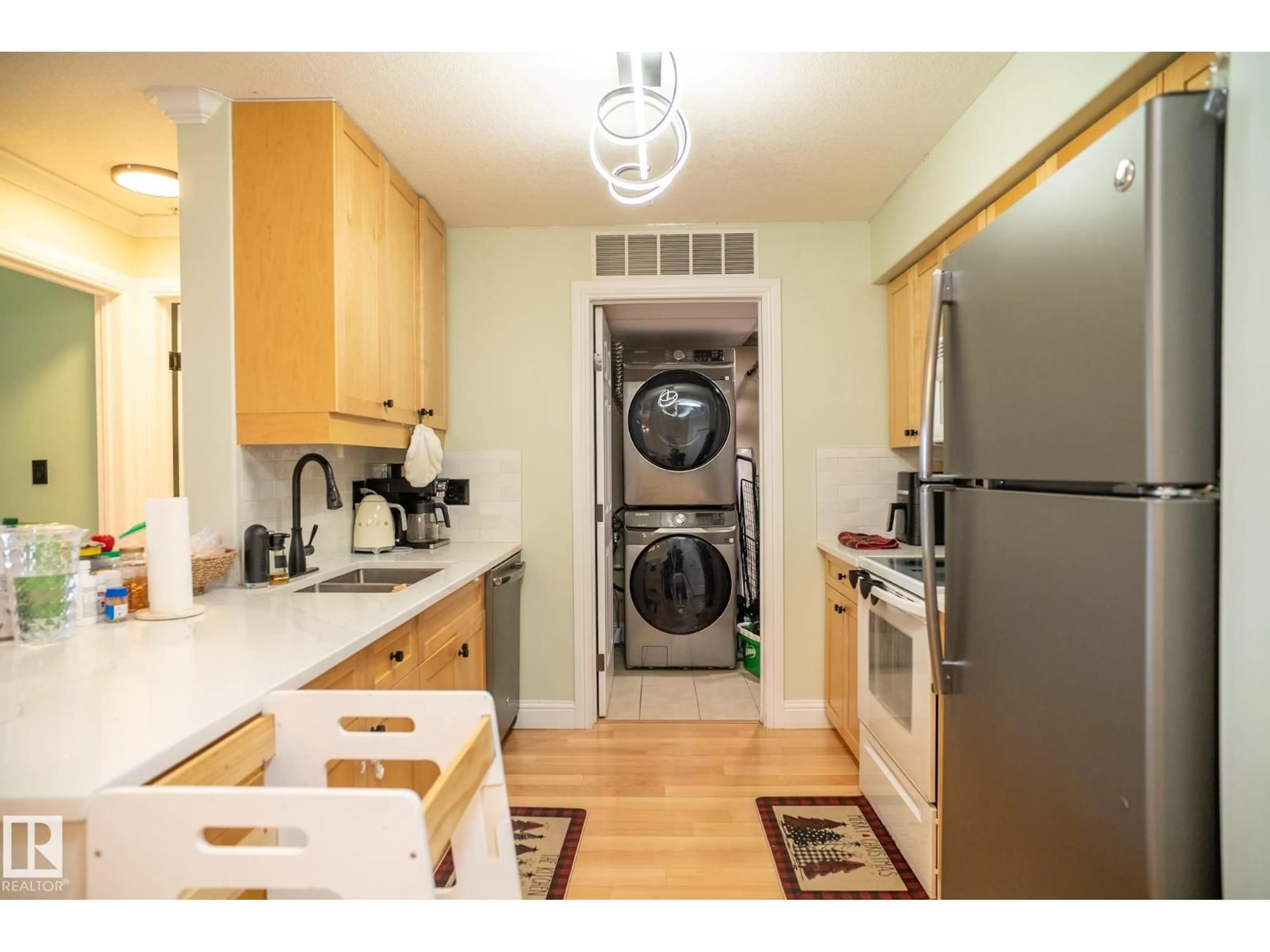 Kitchen with laundary machines, wood/laminate floor for #307 - 13111 140 AV, Edmonton Alberta T6V0B1