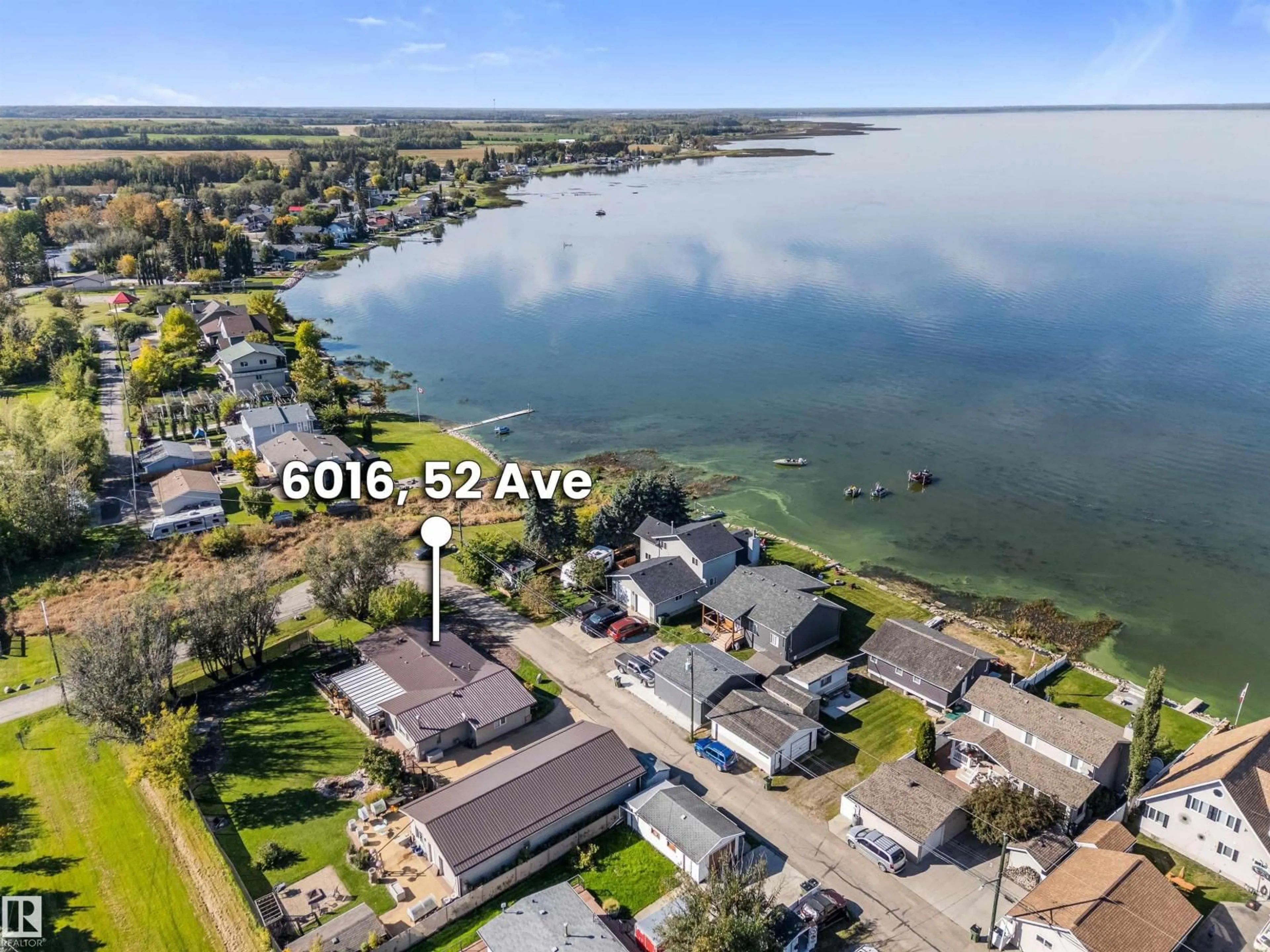 A pic from outside/outdoor area/front of a property/back of a property/a pic from drone, water/lake/river/ocean view for 6016 52 AV, Rural Lac Ste. Anne County Alberta T0E0A0