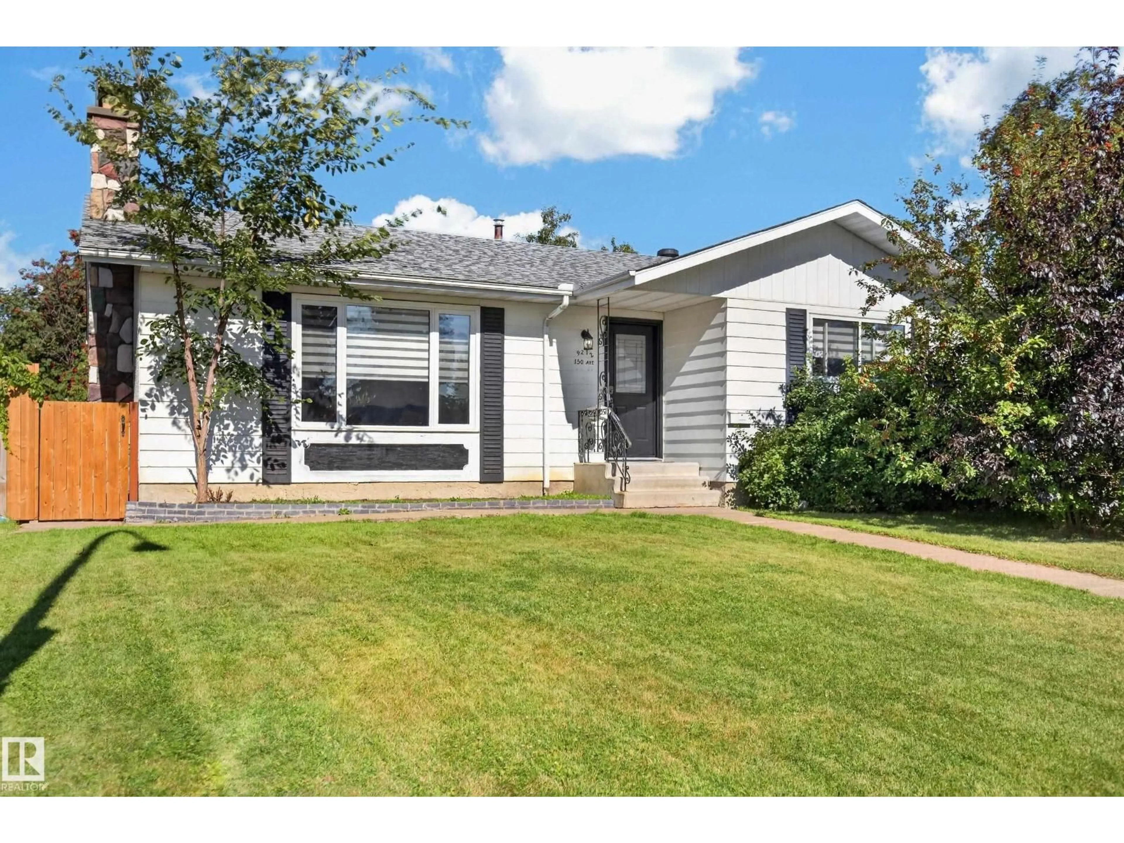 Home with vinyl exterior material, street for NW - 9212 150 AV, Edmonton Alberta T5E2N6