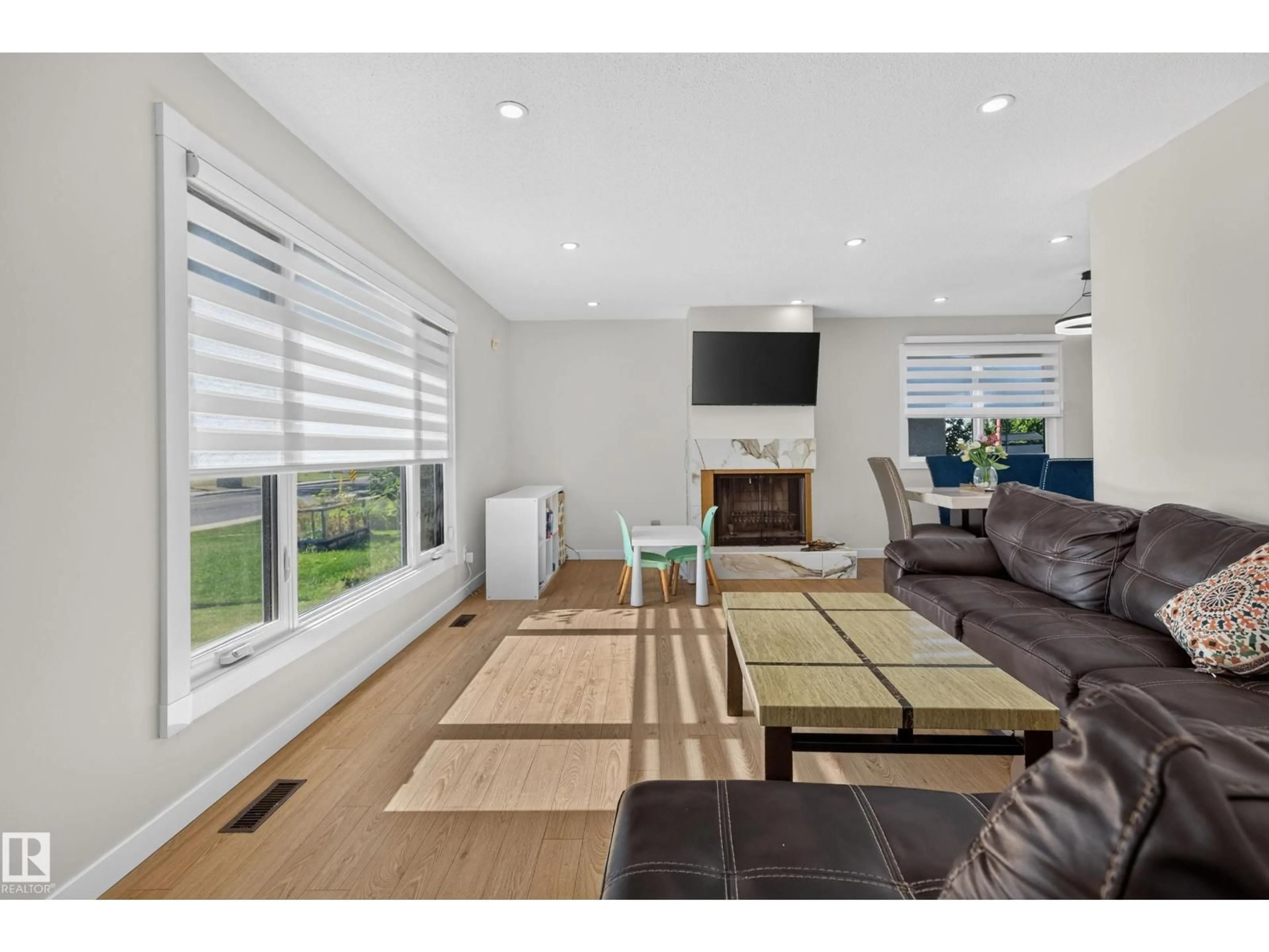 Living room with furniture, wood/laminate floor for NW - 9212 150 AV, Edmonton Alberta T5E2N6