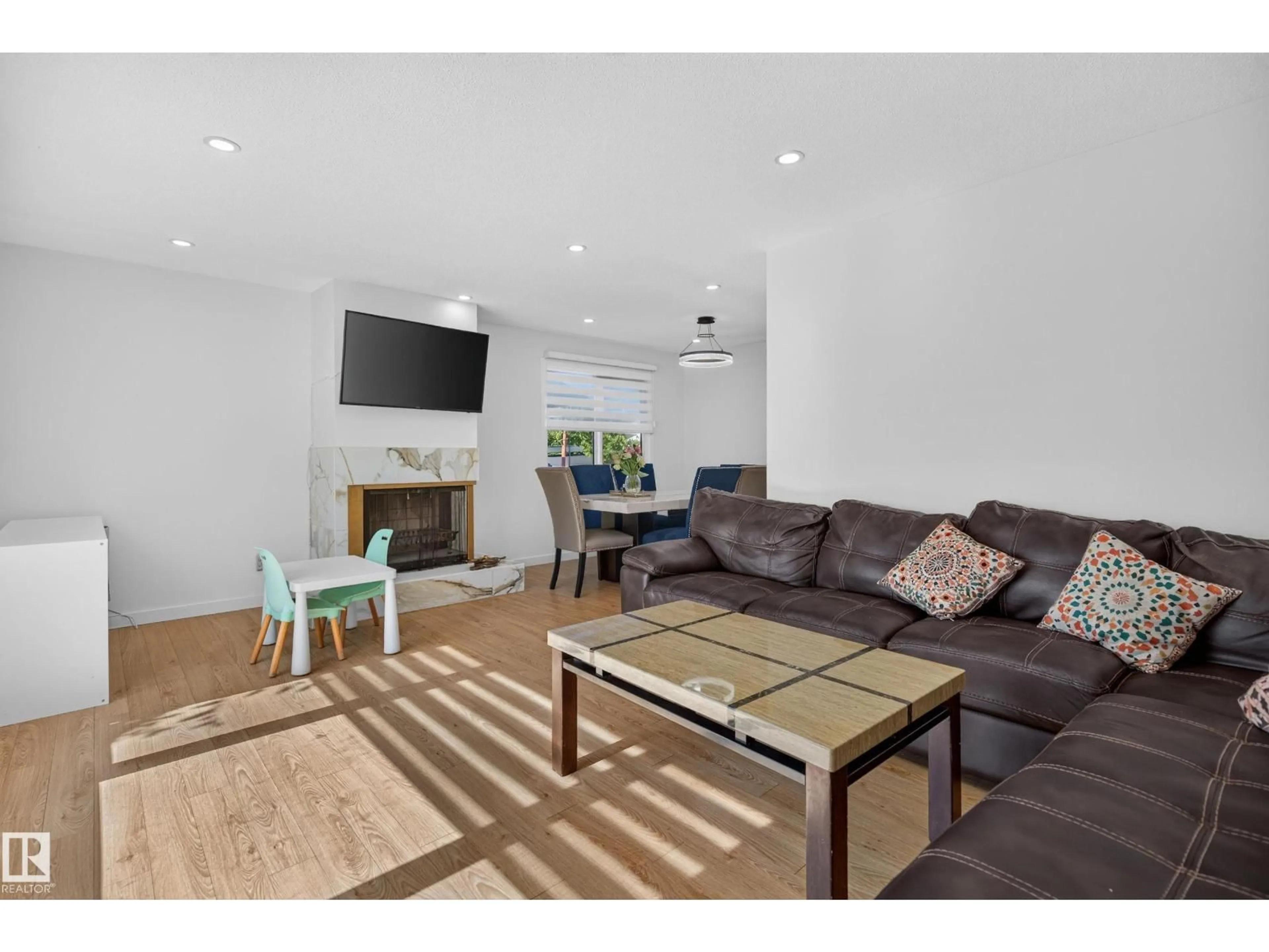 Living room with furniture, wood/laminate floor for NW - 9212 150 AV, Edmonton Alberta T5E2N6