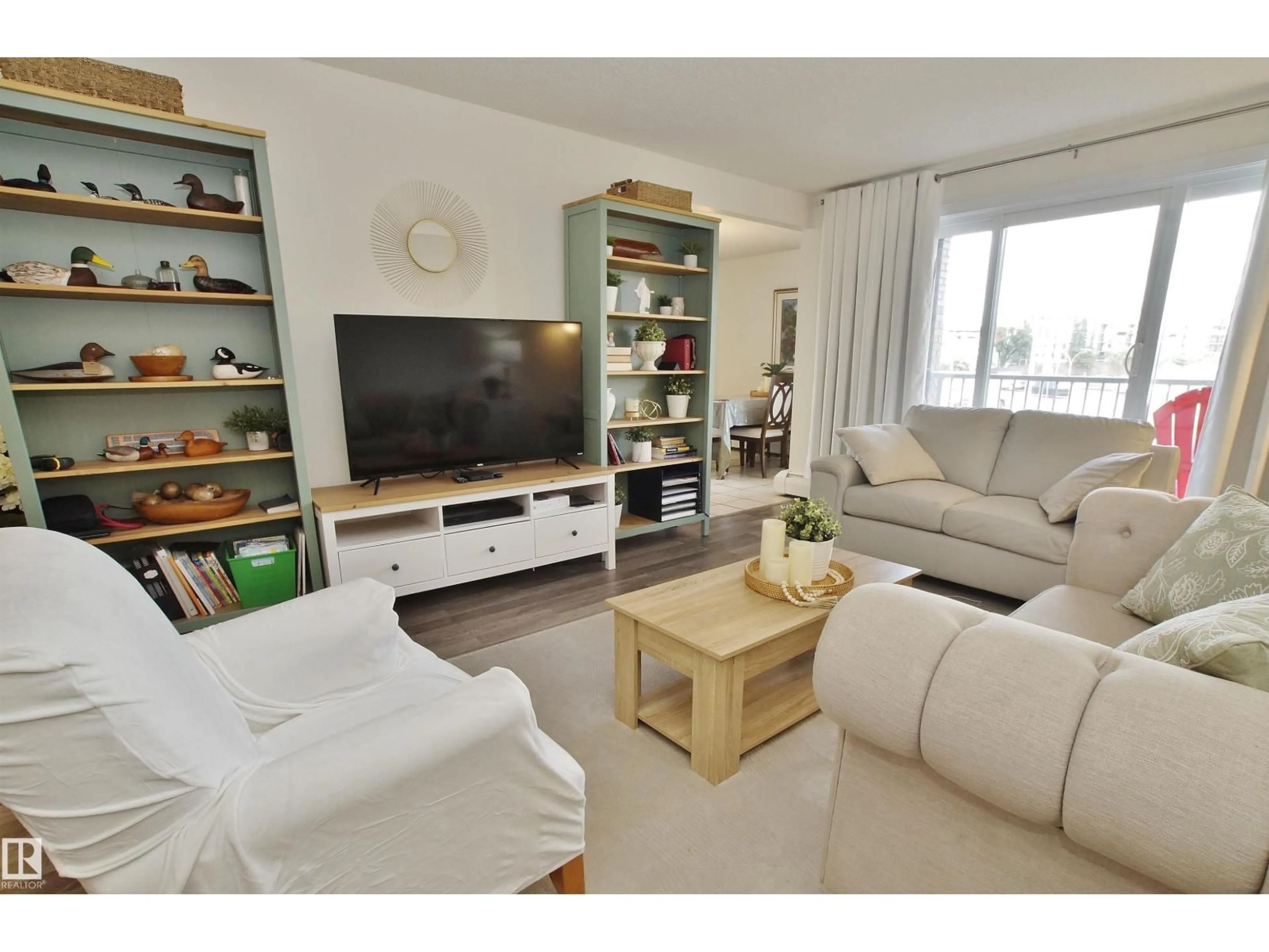 Living room with furniture, wood/laminate floor for 235 - 4404 122 ST, Edmonton Alberta T6J4A9
