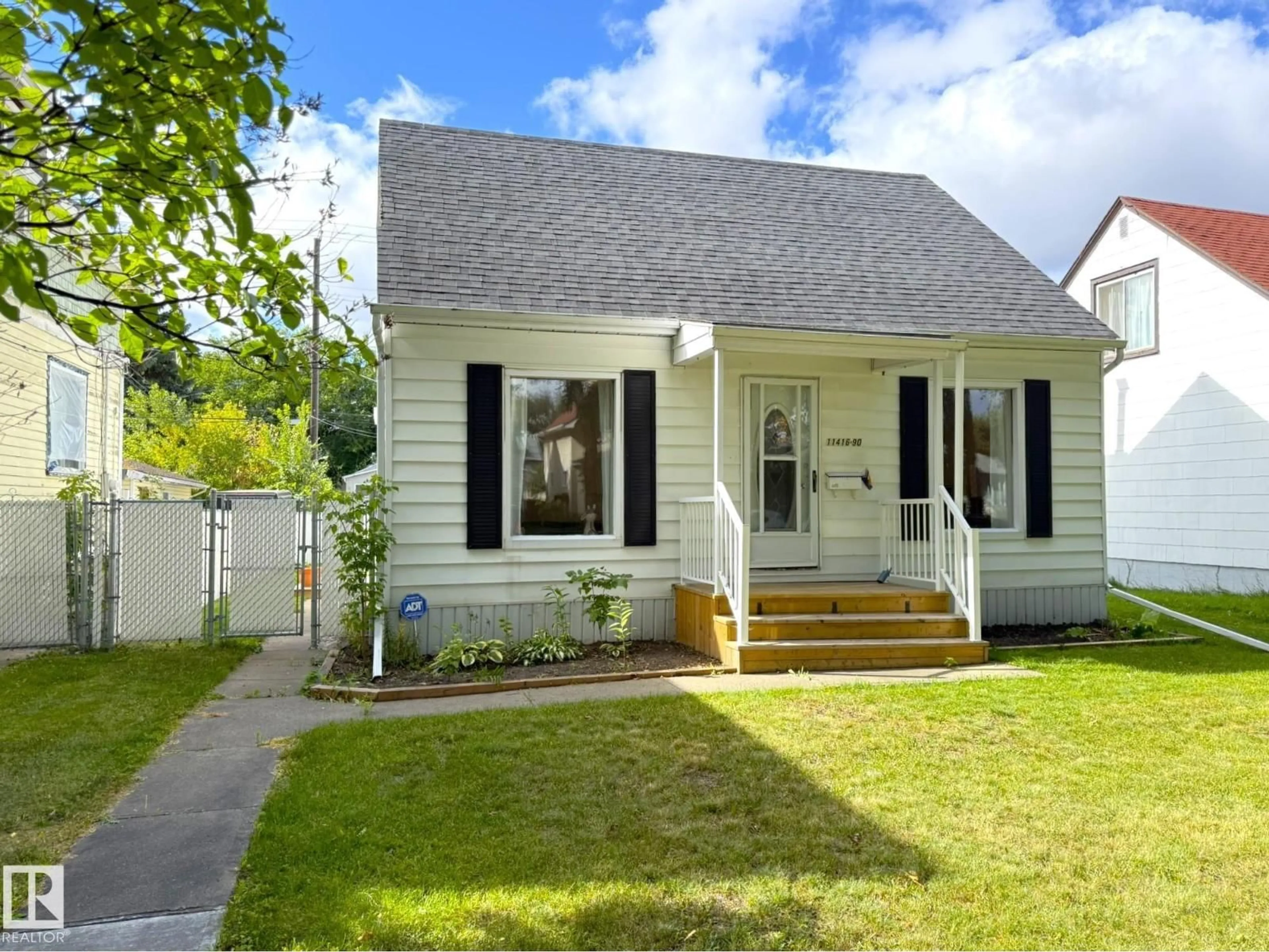 Home with vinyl exterior material, street for 11416 90 ST, Edmonton Alberta T5B3X7
