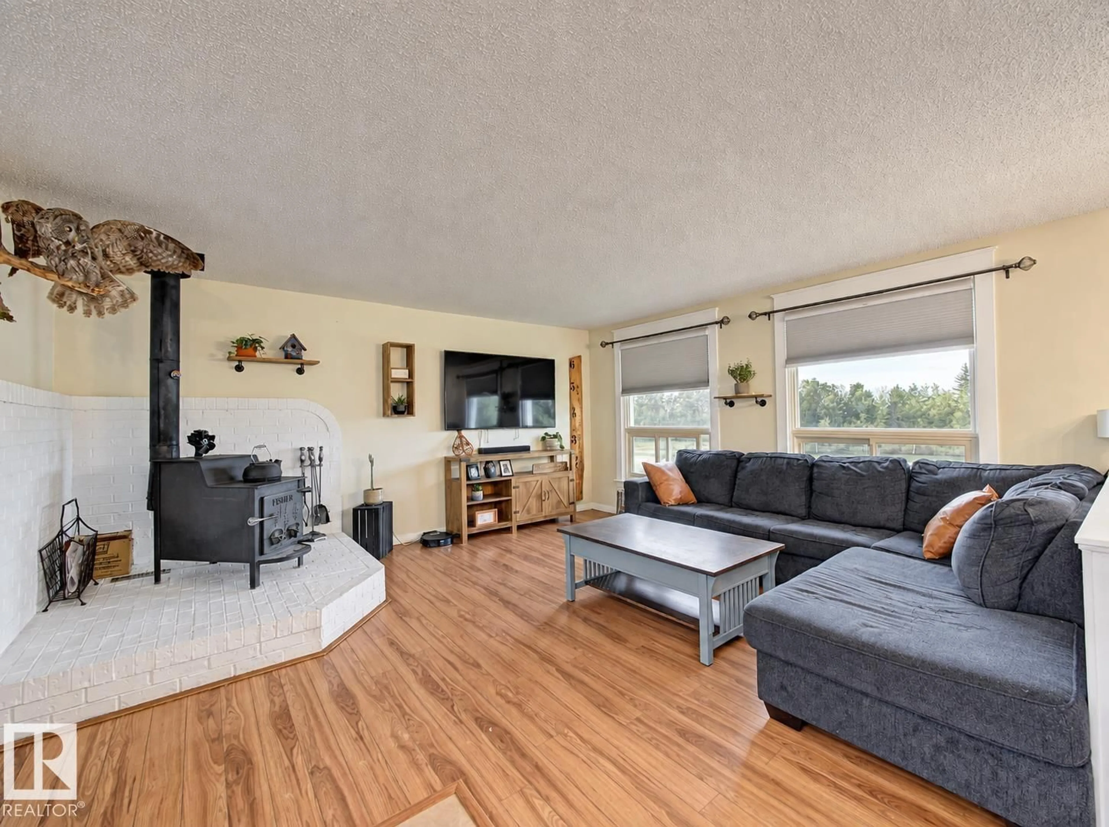 Living room with furniture, wood/laminate floor for 57511 RR 224, Rural Sturgeon County Alberta T0A2W0