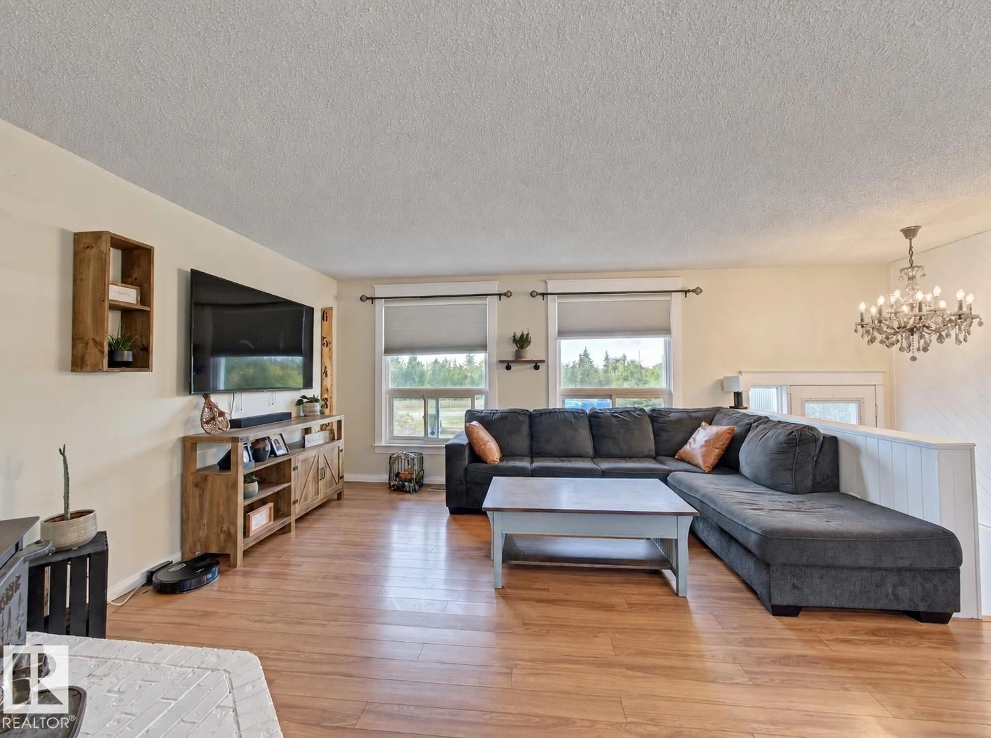 Living room with furniture, wood/laminate floor for 57511 RR 224, Rural Sturgeon County Alberta T0A2W0