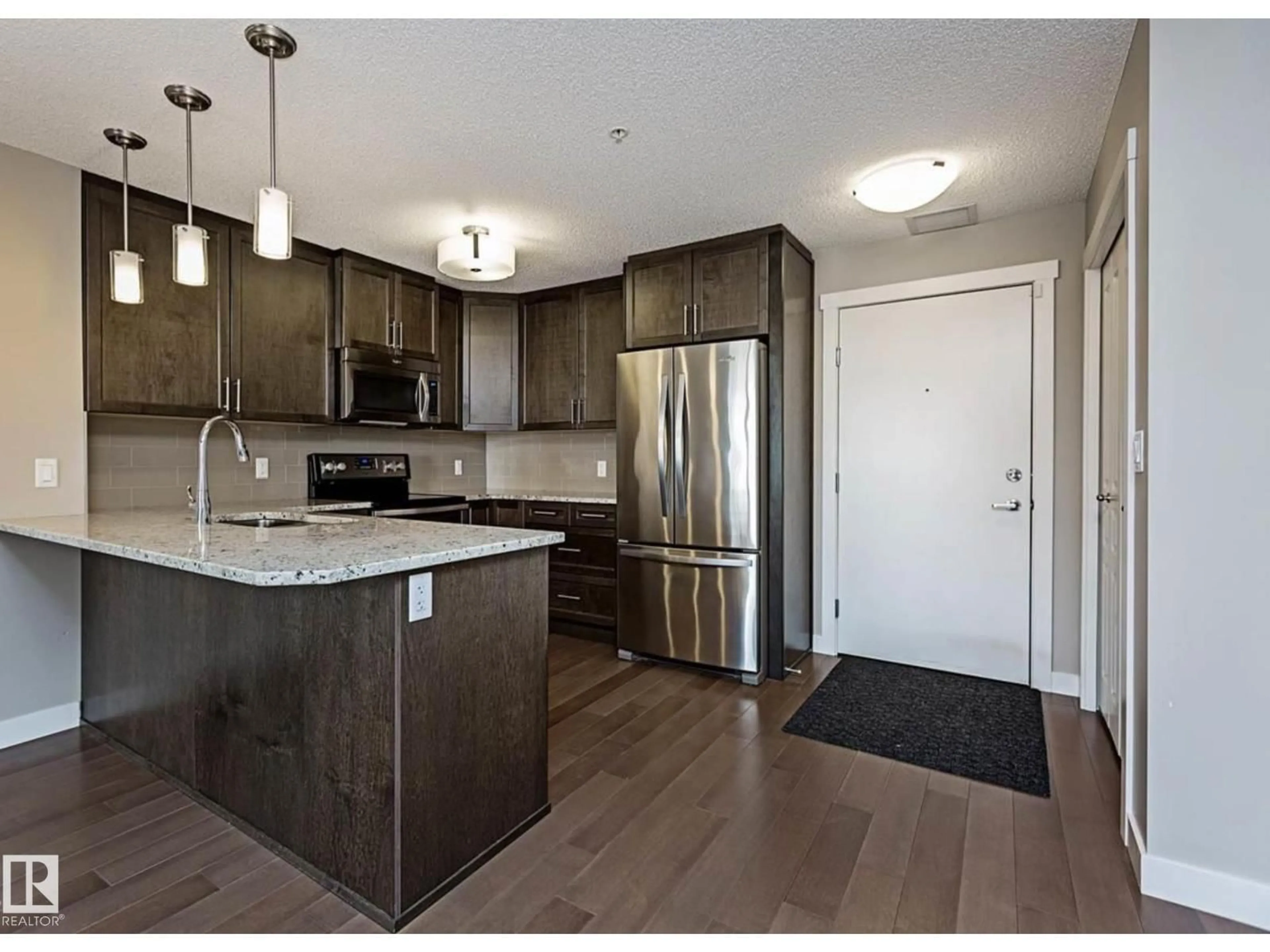 Open concept kitchen, wood/laminate floor for 109 - 2207 44 AV NW, Edmonton Alberta T6T0T2