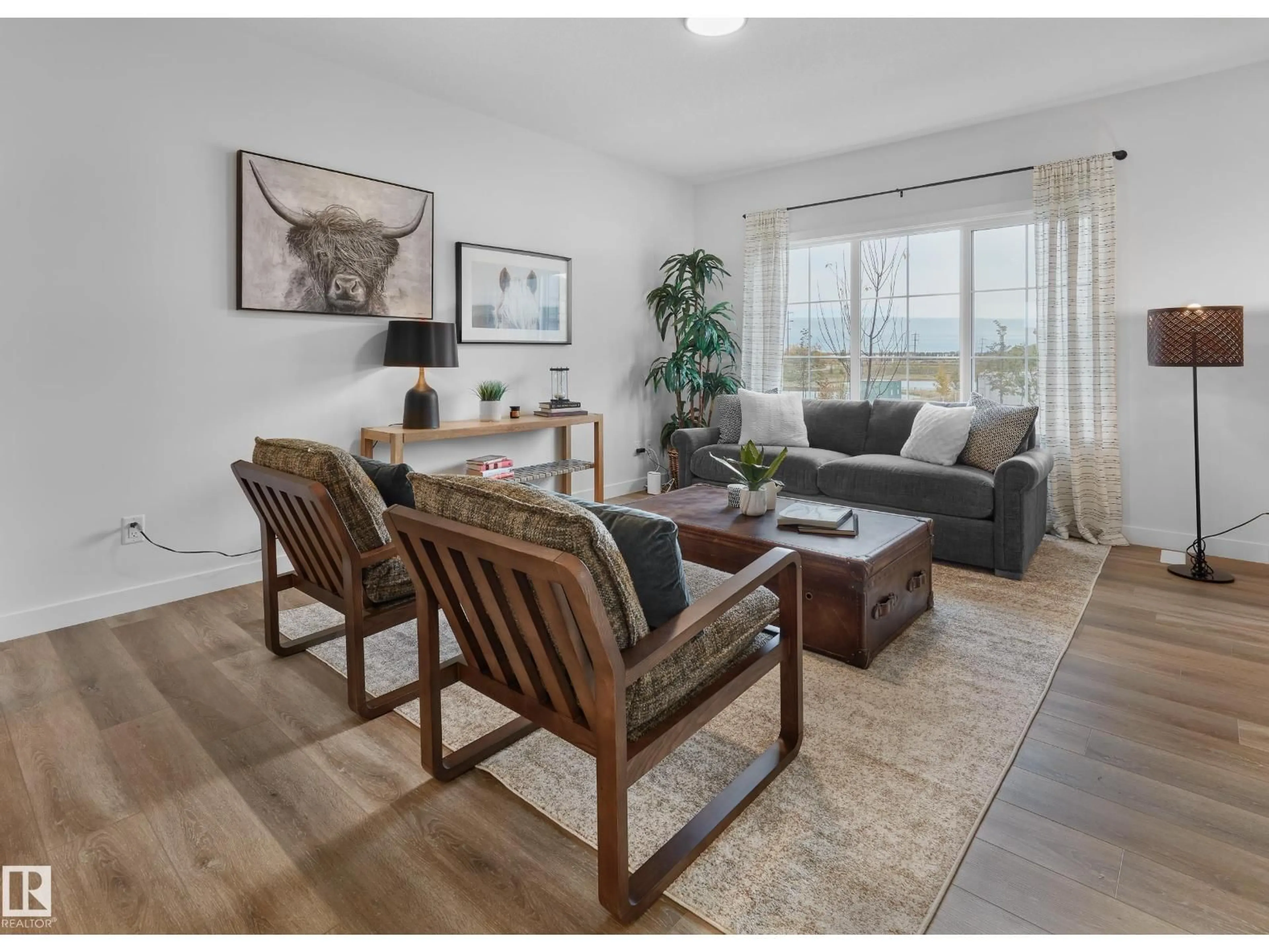 Living room with furniture, wood/laminate floor for 129 CHELLES WD, St. Albert Alberta T8T2C2