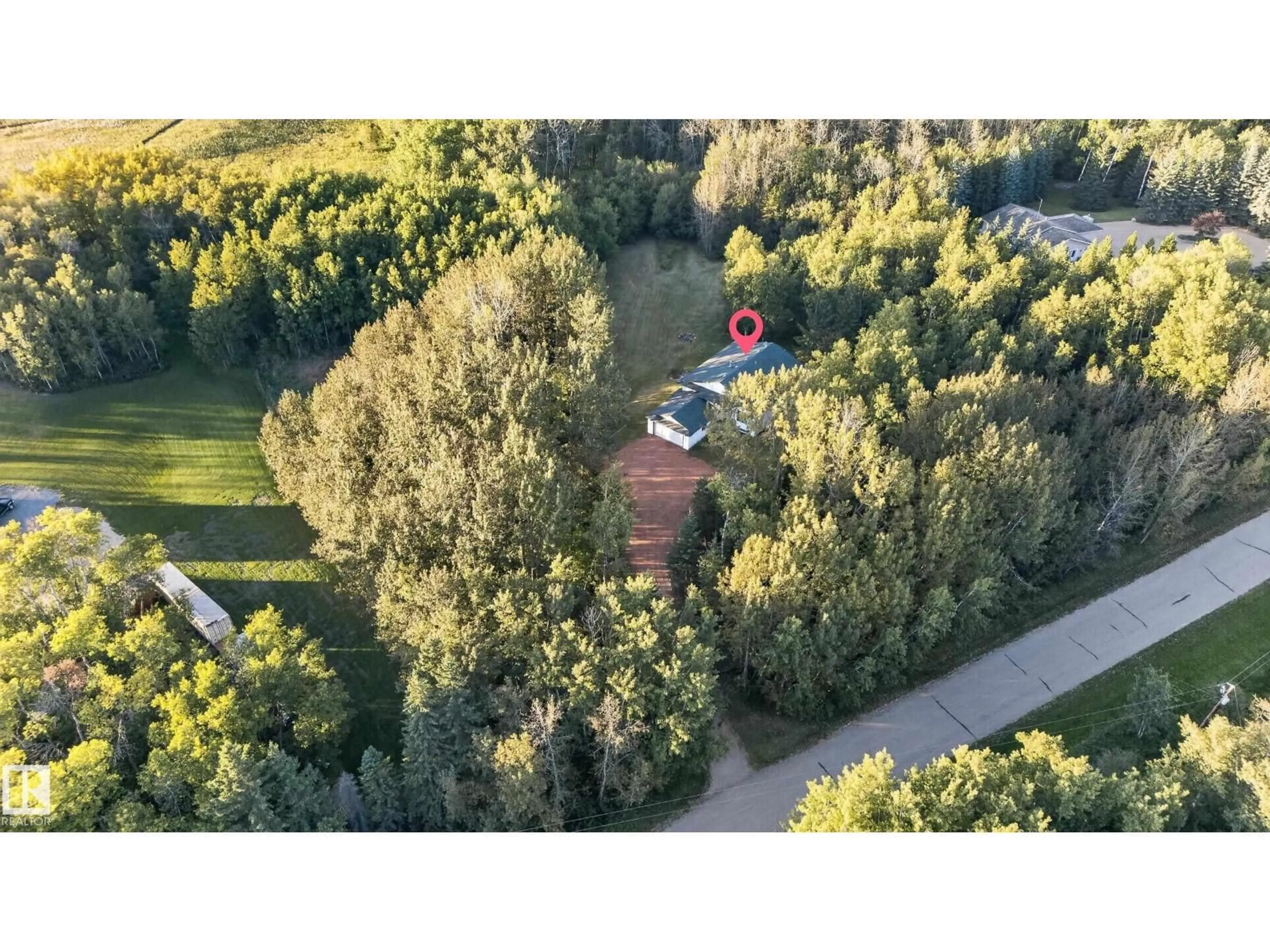 A pic from outside/outdoor area/front of a property/back of a property/a pic from drone, forest/trees view for 310 - 50247 RGE RD 232, Rural Leduc County Alberta T4X0K9