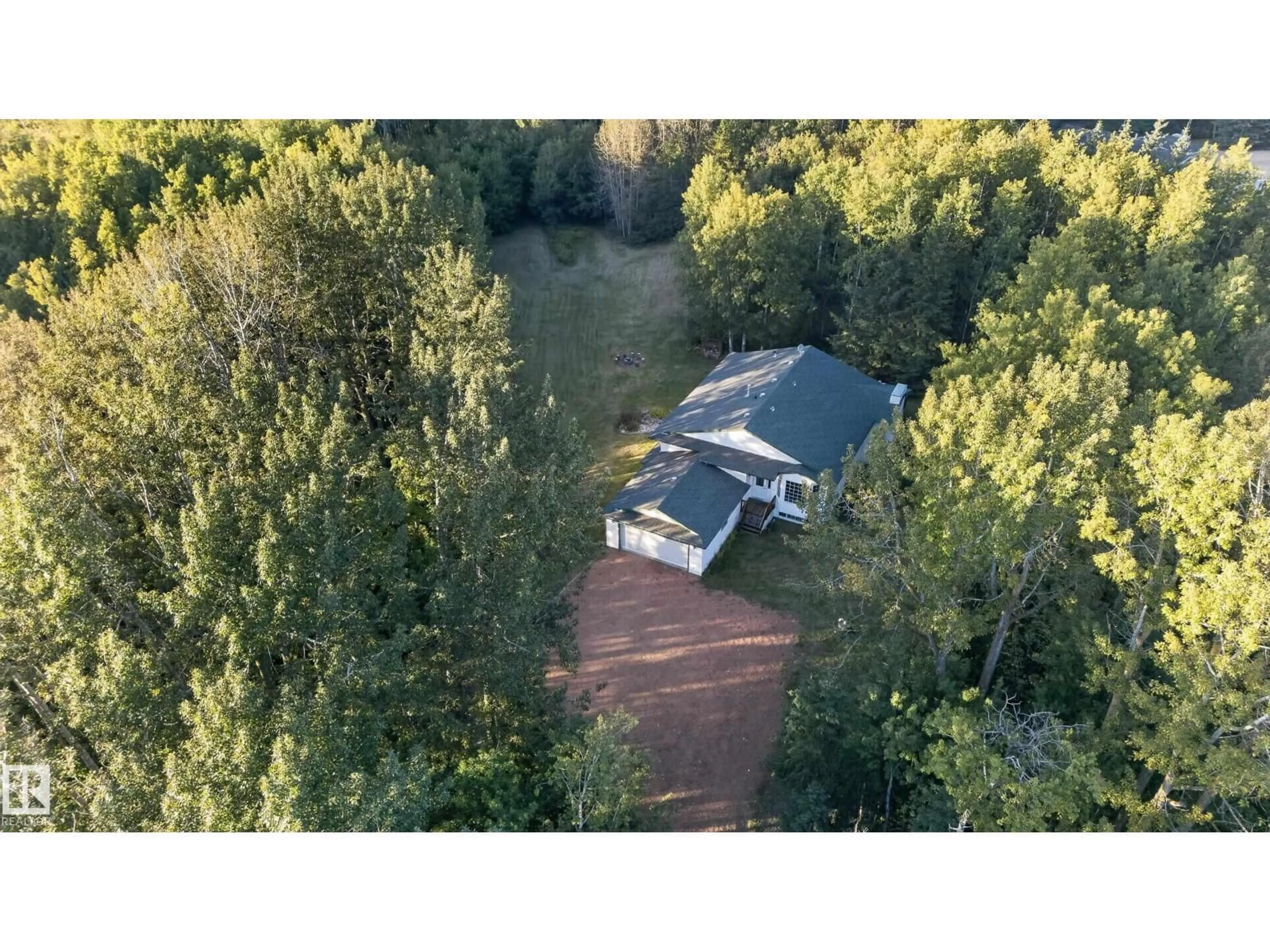 A pic from outside/outdoor area/front of a property/back of a property/a pic from drone, forest/trees view for 310 - 50247 RGE RD 232, Rural Leduc County Alberta T4X0K9