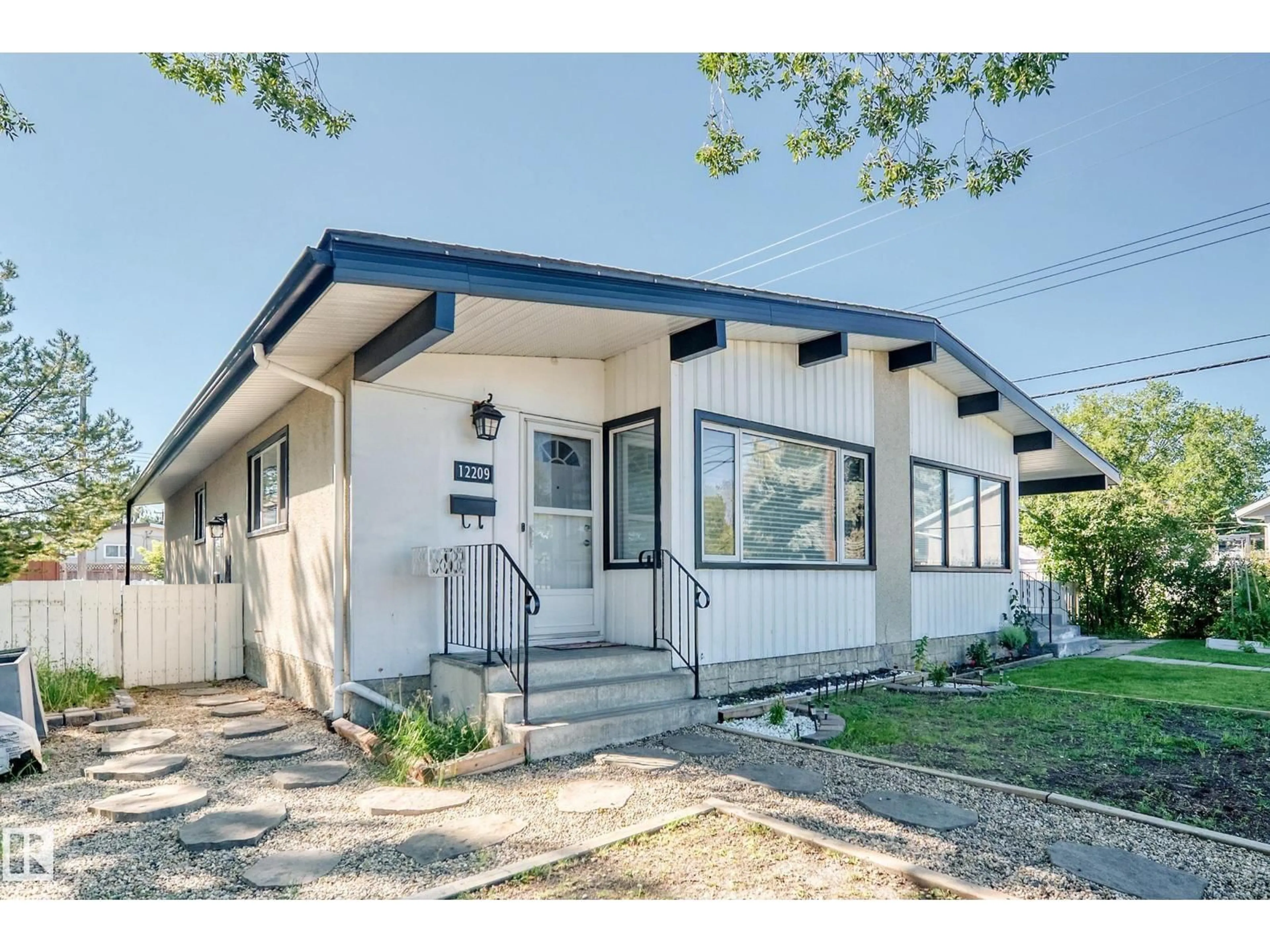 Home with vinyl exterior material, street for NW - 12209 134B AV, Edmonton Alberta T5L3W9