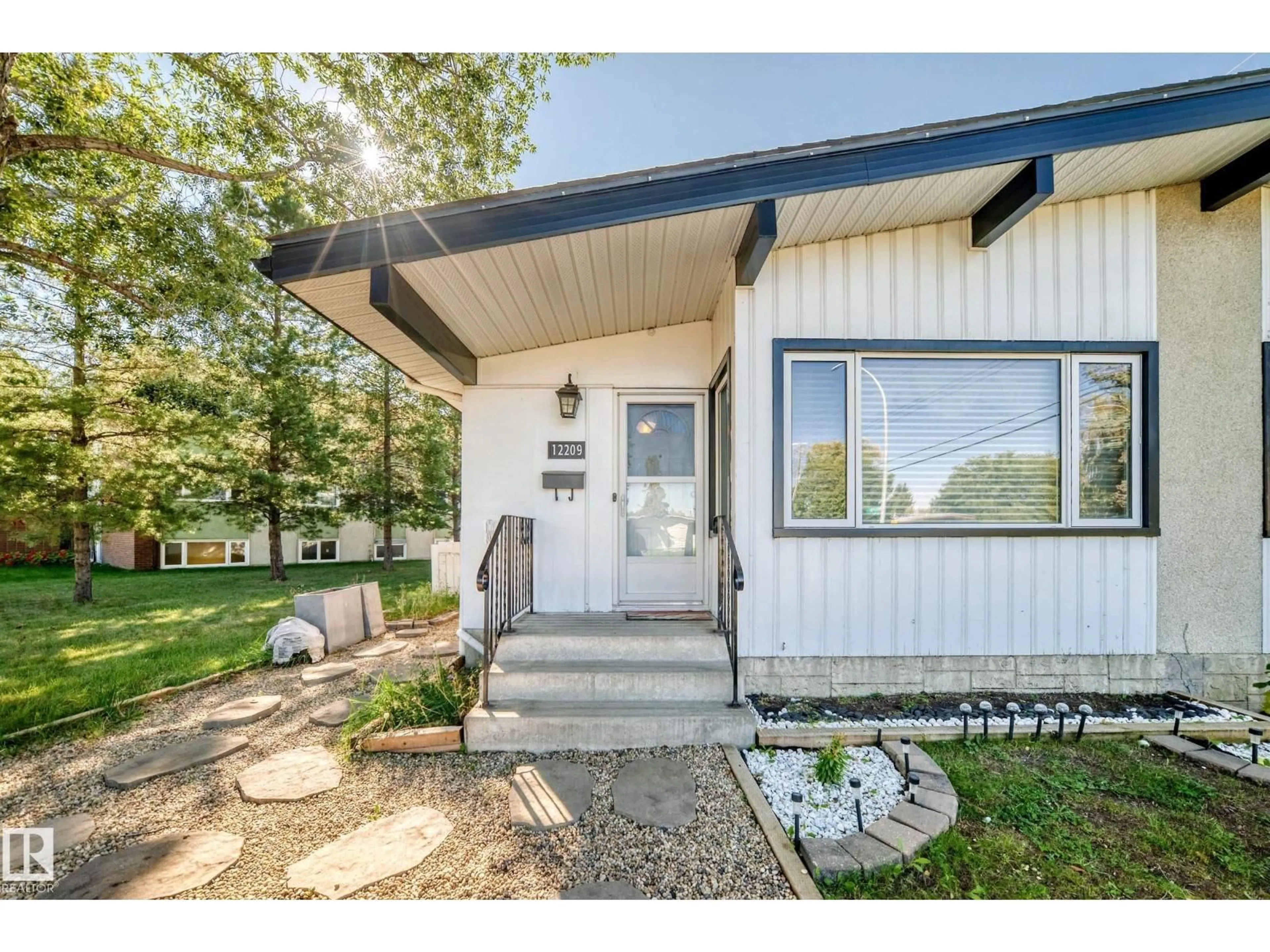 Home with vinyl exterior material, street for NW - 12209 134B AV, Edmonton Alberta T5L3W9