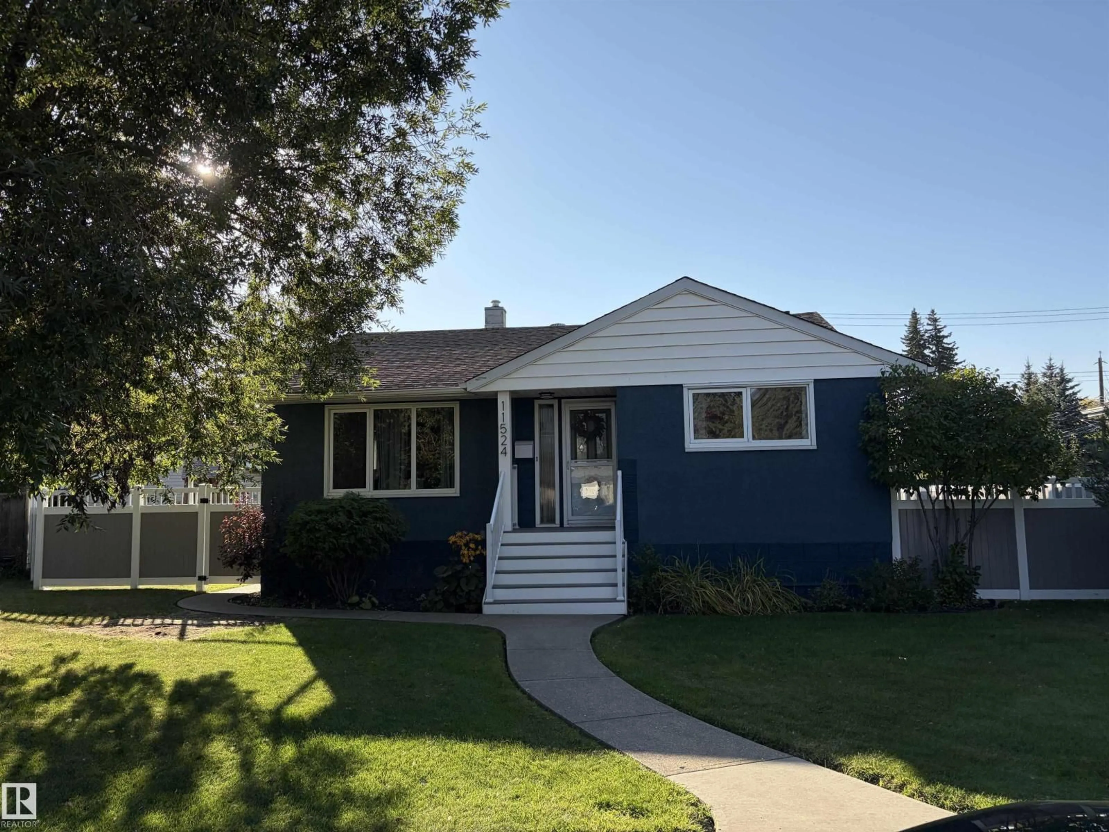 Home with vinyl exterior material, street for 11524 133 ST, Edmonton Alberta T5M1H4