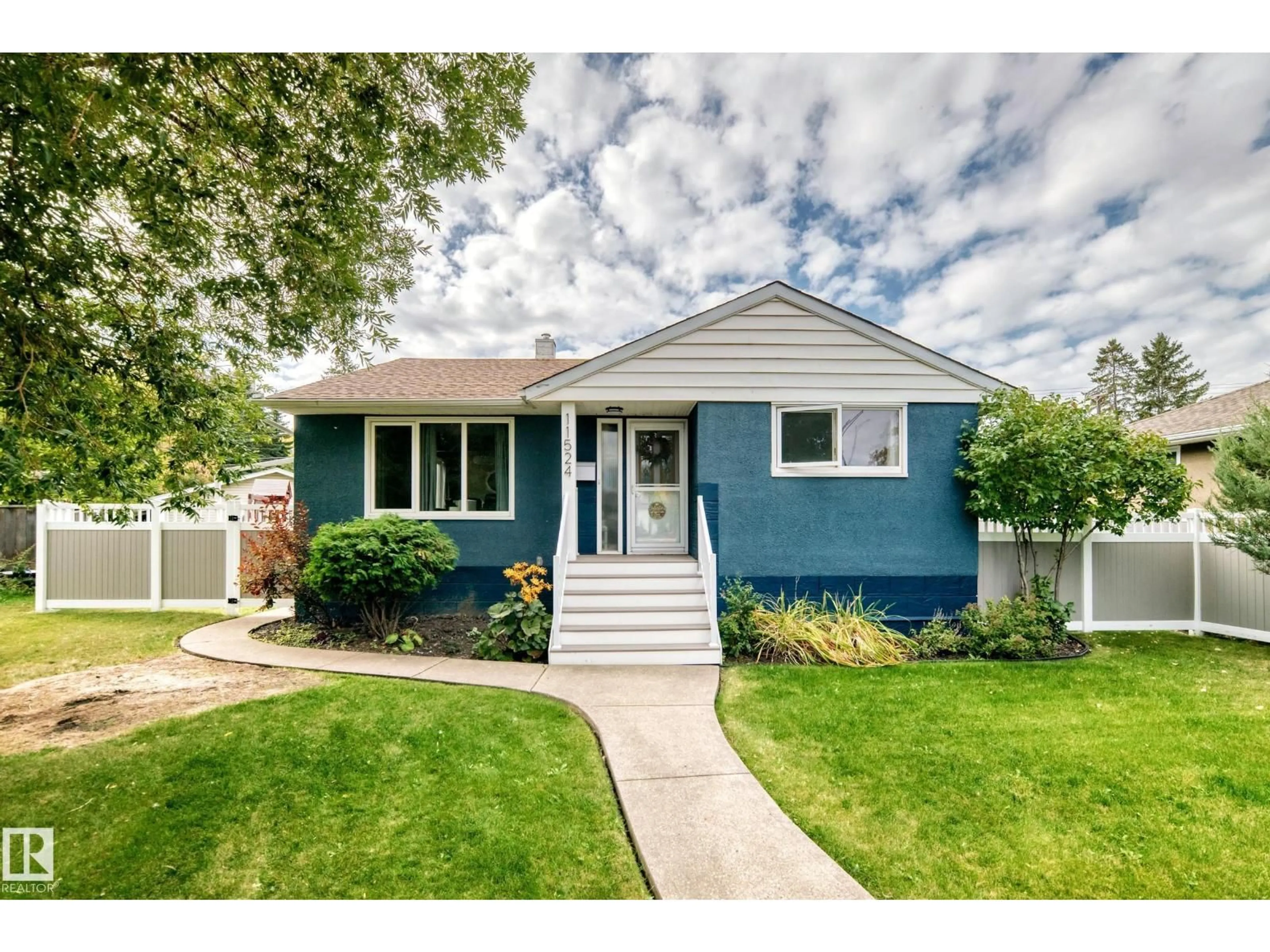 Home with vinyl exterior material, street for 11524 133 ST, Edmonton Alberta T5M1H4