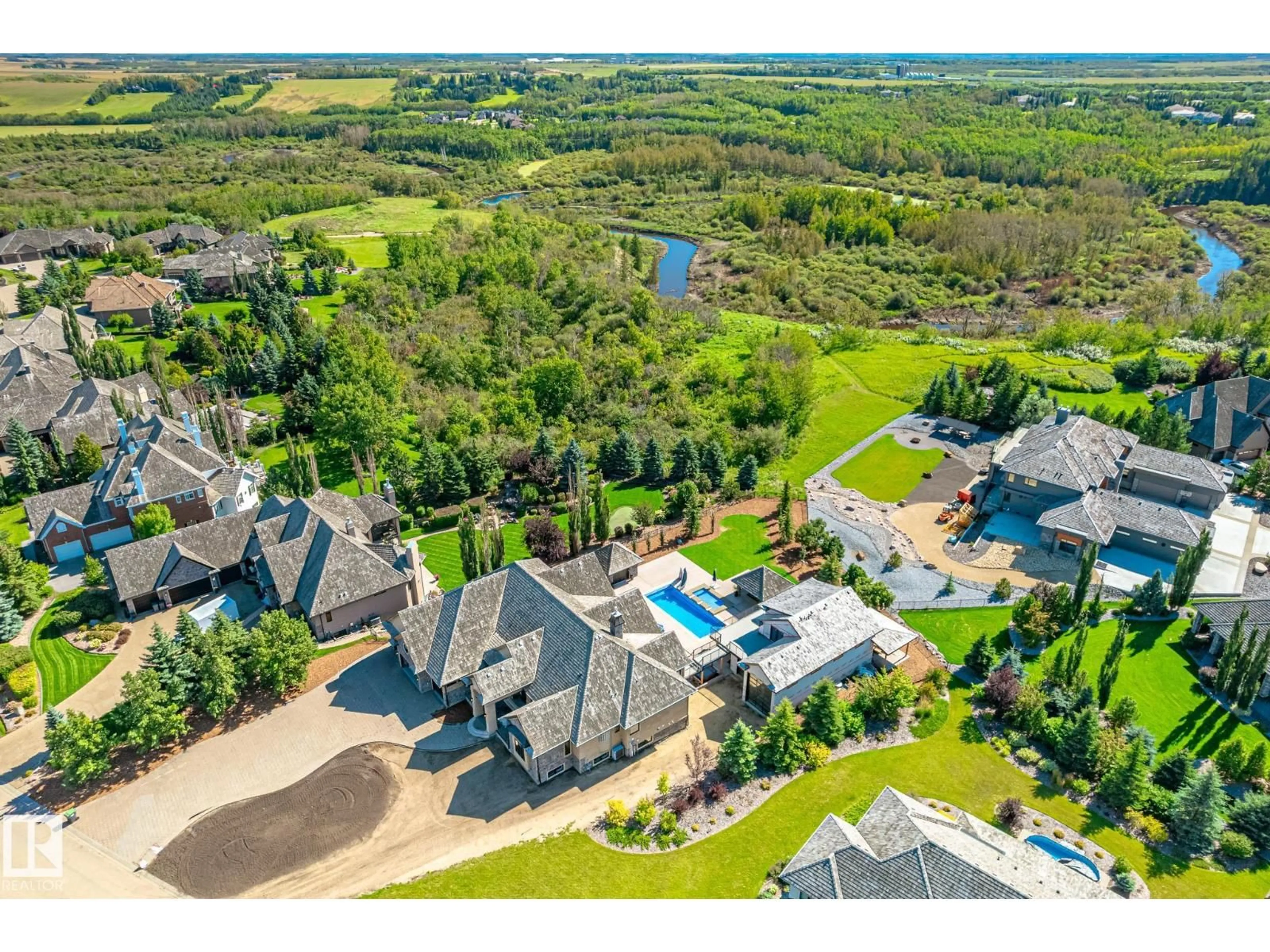 A pic from outside/outdoor area/front of a property/back of a property/a pic from drone, water/lake/river/ocean view for 185 RIVERSTONE DR, Rural Sturgeon County Alberta T8T0B9