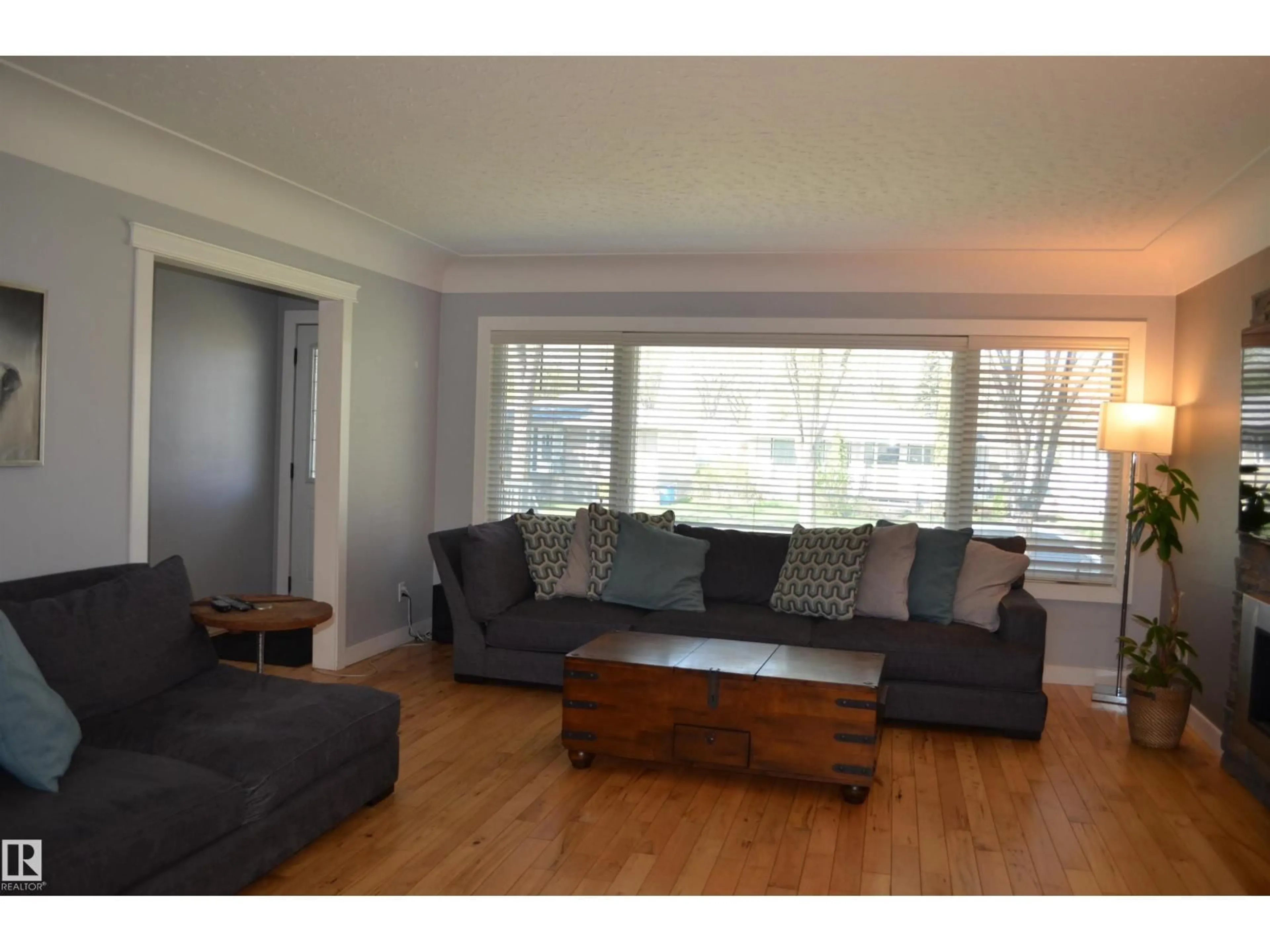 Living room with furniture, wood/laminate floor for NW - 10527 81 ST, Edmonton Alberta T6A3L3
