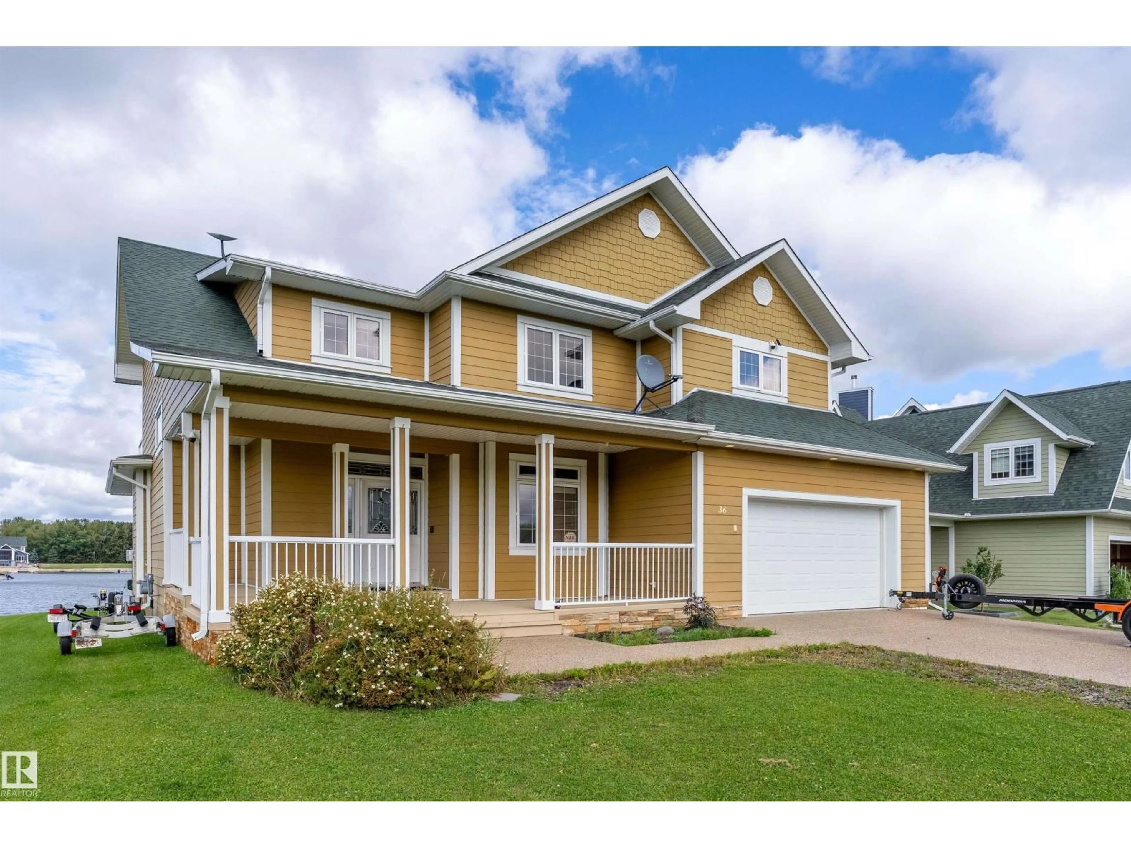 Home with vinyl exterior material, street for 36 SUNSET HARBOUR, Rural Wetaskiwin County Alberta T0C2V0