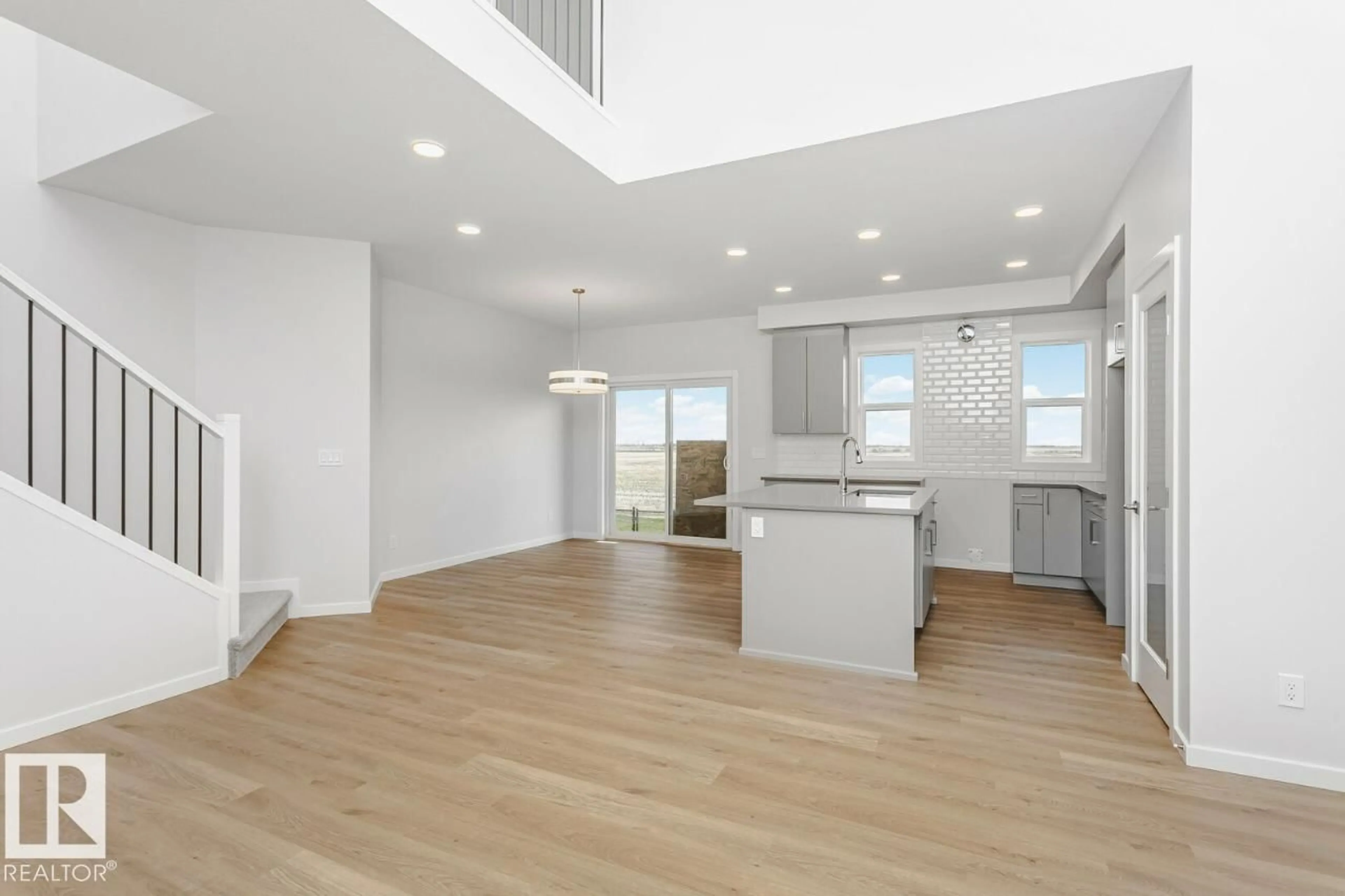 Open concept kitchen, wood/laminate floor for 264 LODGE POLE PL, Leduc Alberta T4X0L1