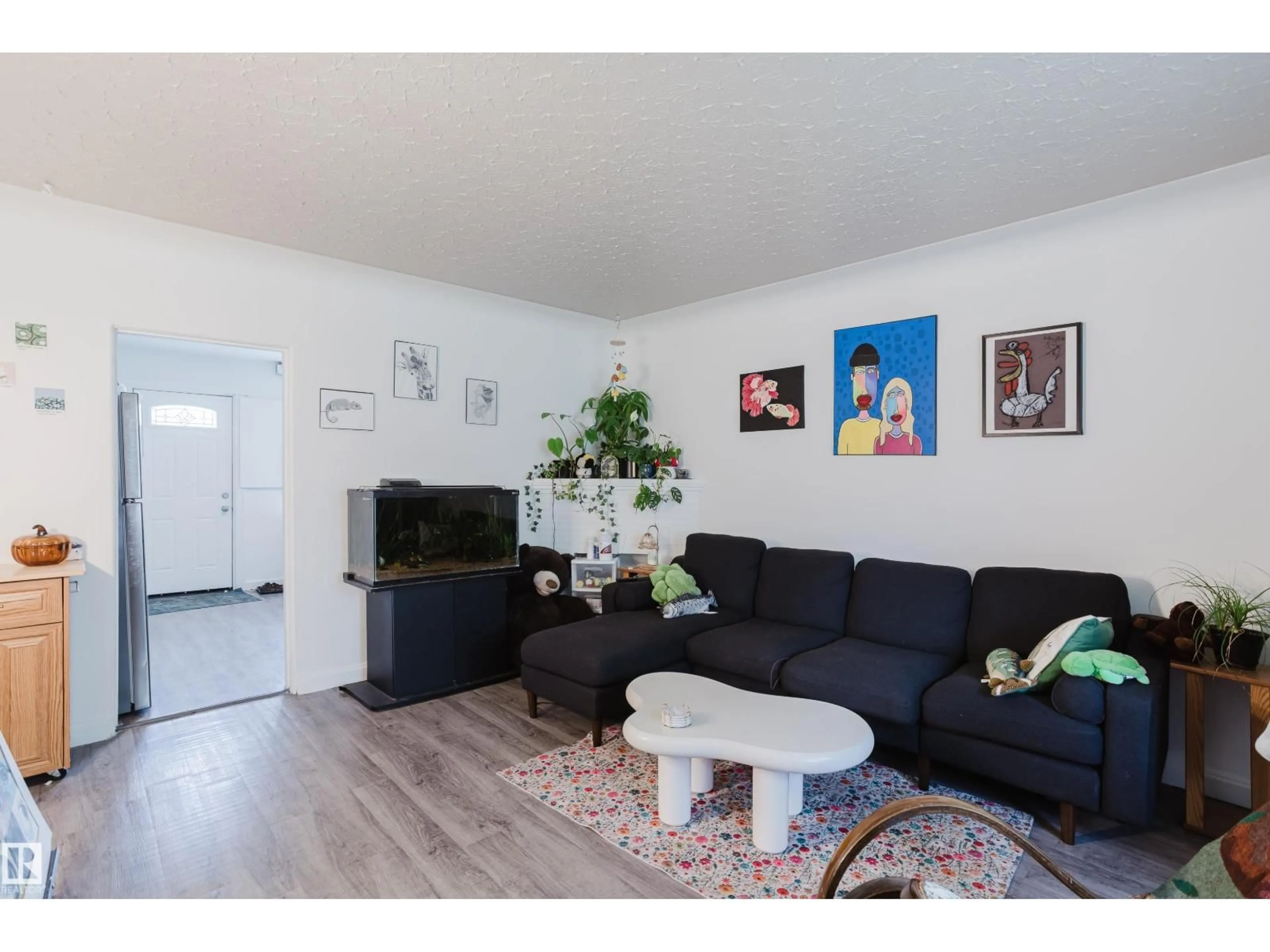 Living room with furniture, wood/laminate floor for 11134 116 ST, Edmonton Alberta T5G2V8