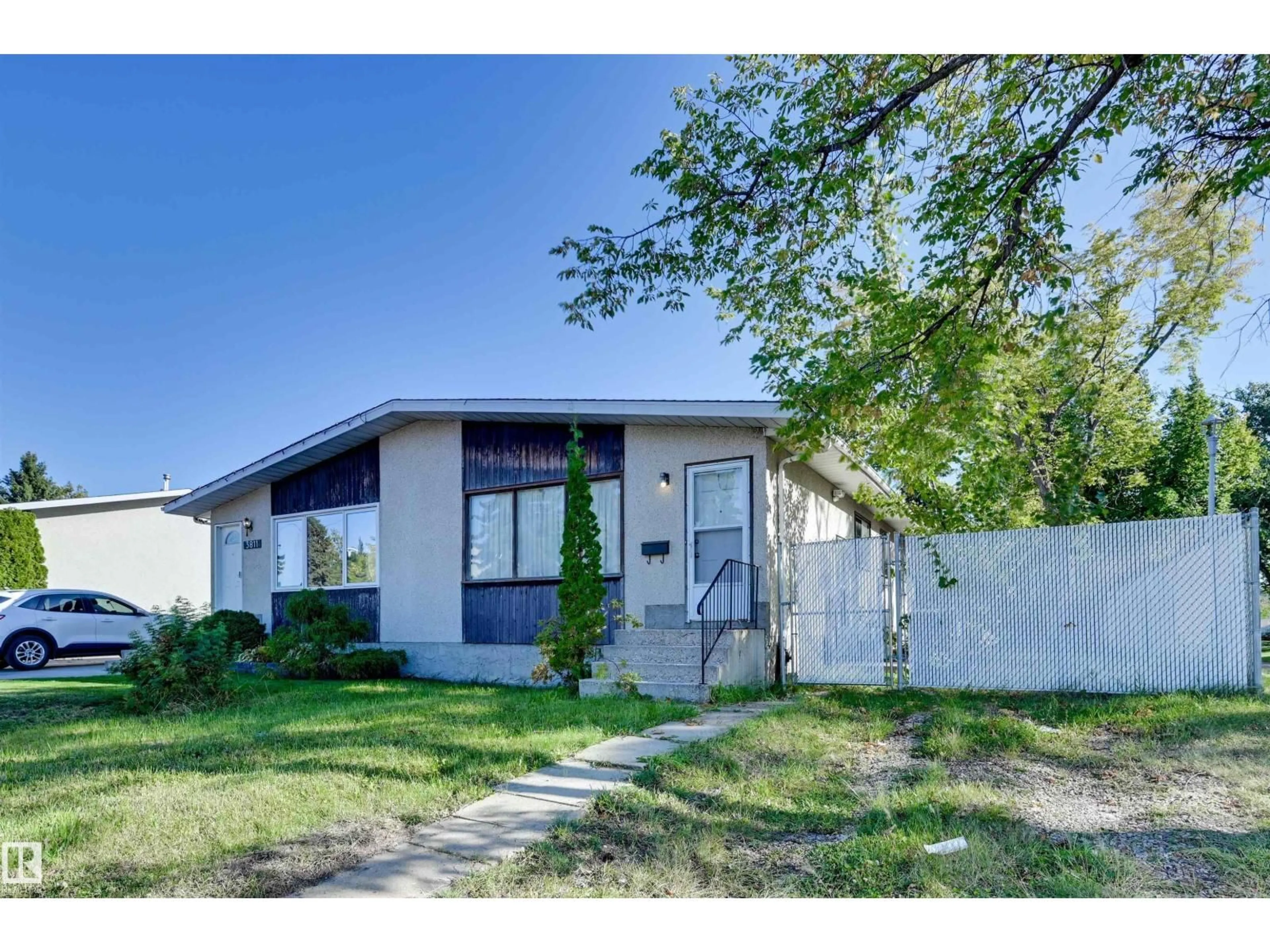 Home with vinyl exterior material, street for 3813 134 AV, Edmonton Alberta T5A3J7