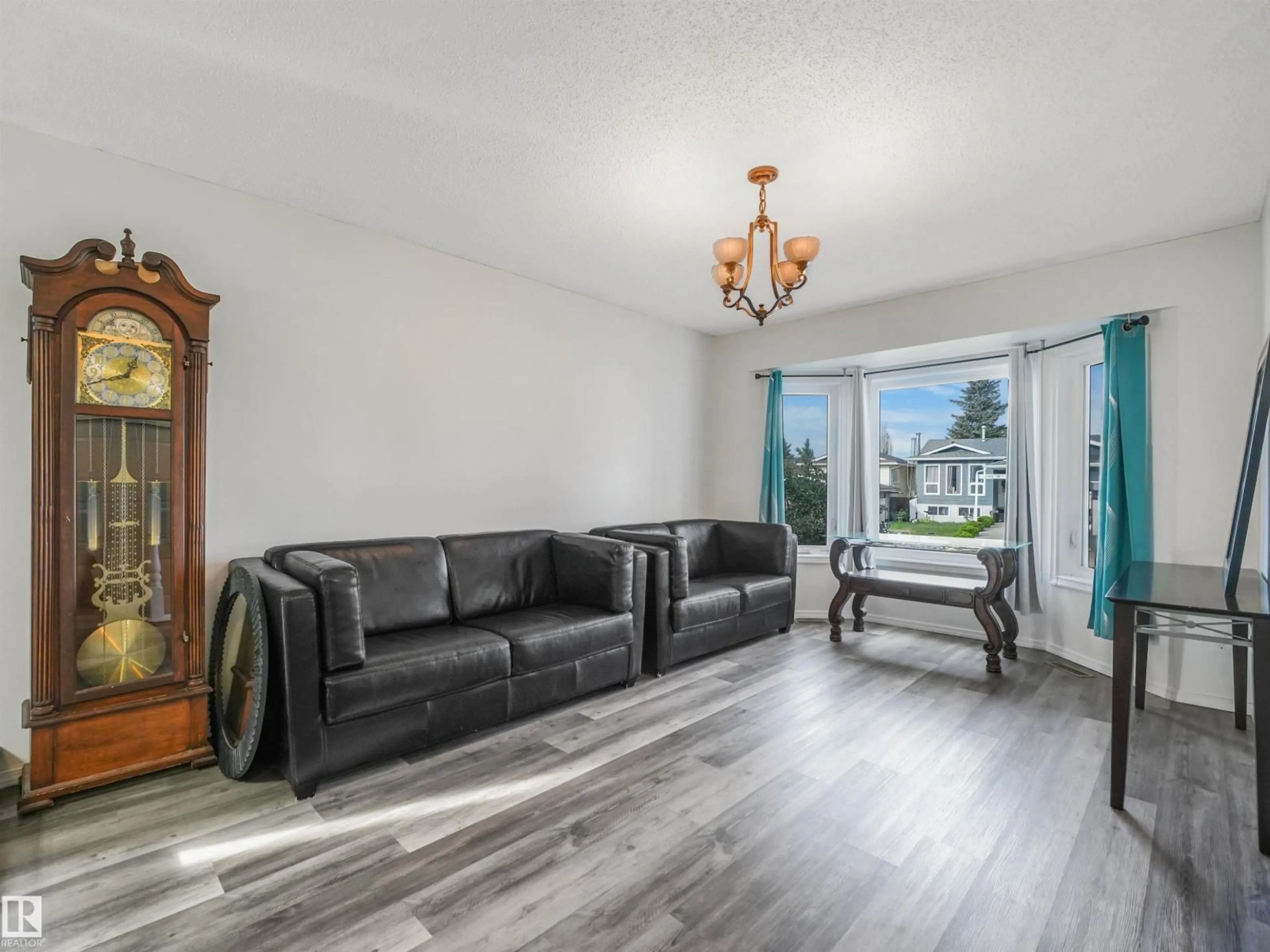 Living room with furniture, wood/laminate floor for 3467 39 ST, Edmonton Alberta T6L3Y9