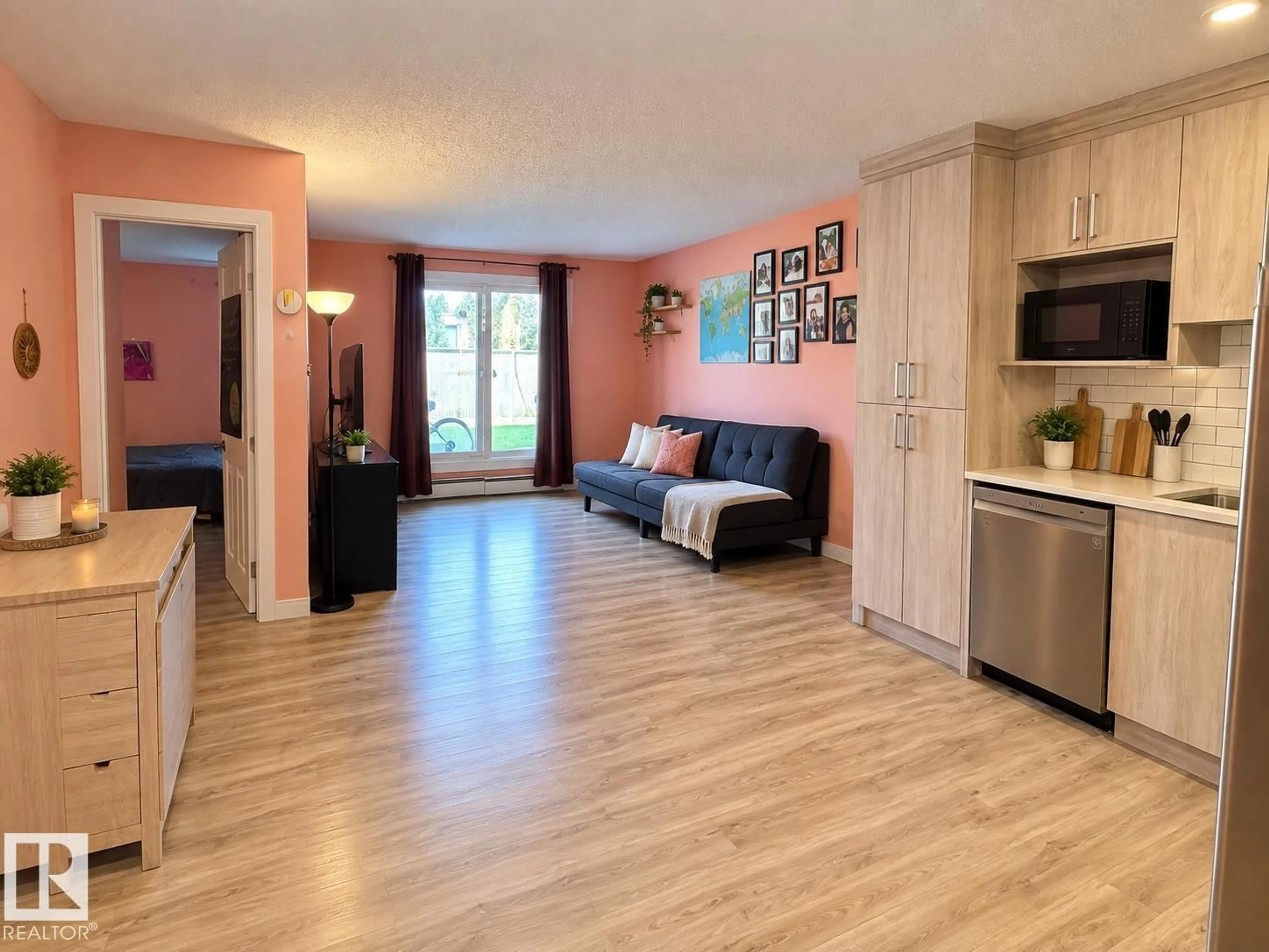 Living room with furniture, wood/laminate floor for #108 - 2624 MILL WOODS RD E, Edmonton Alberta T6L5K7