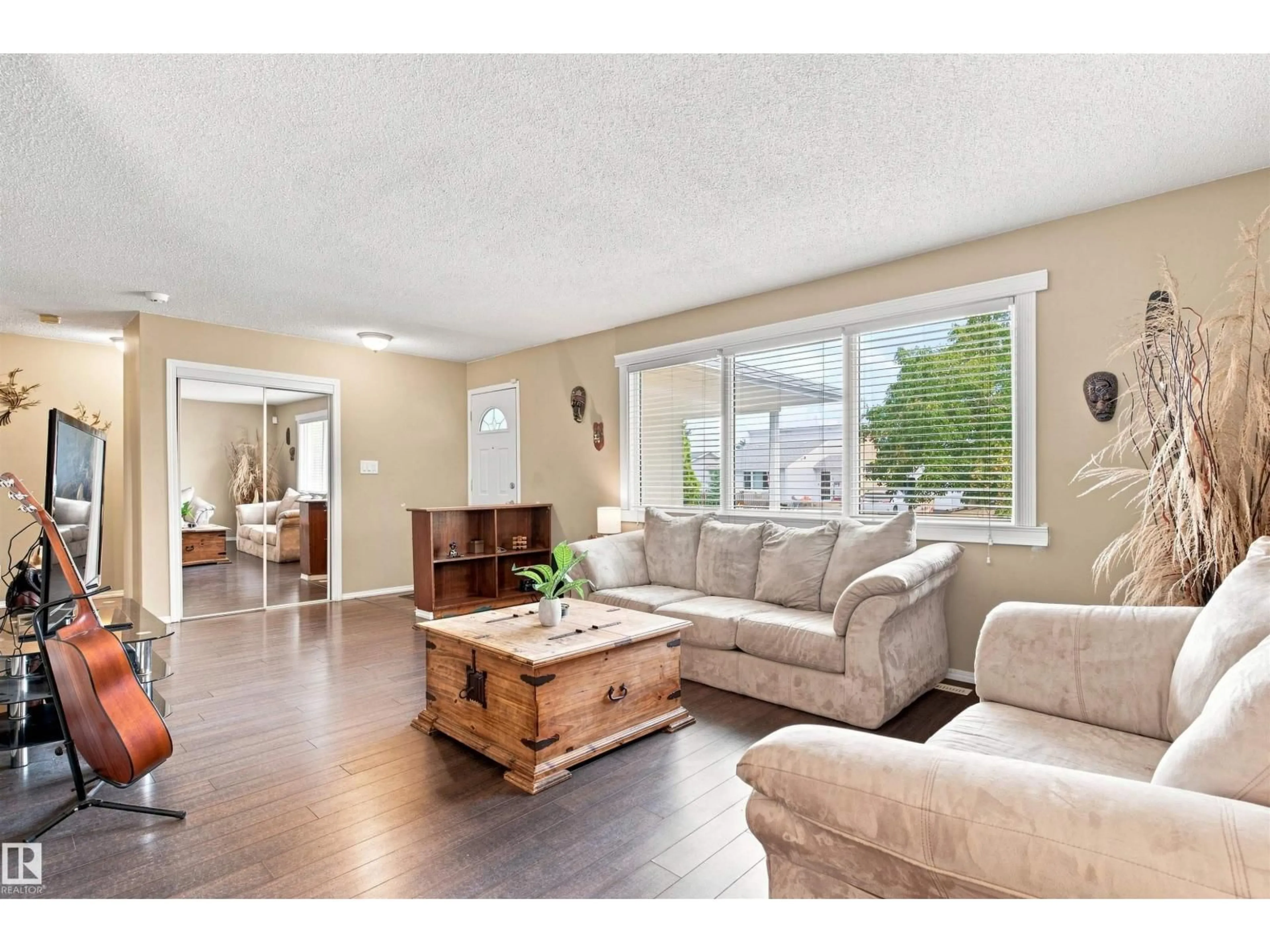 Living room with furniture, wood/laminate floor for 12 HUGHES RD, Edmonton Alberta T5A4E2