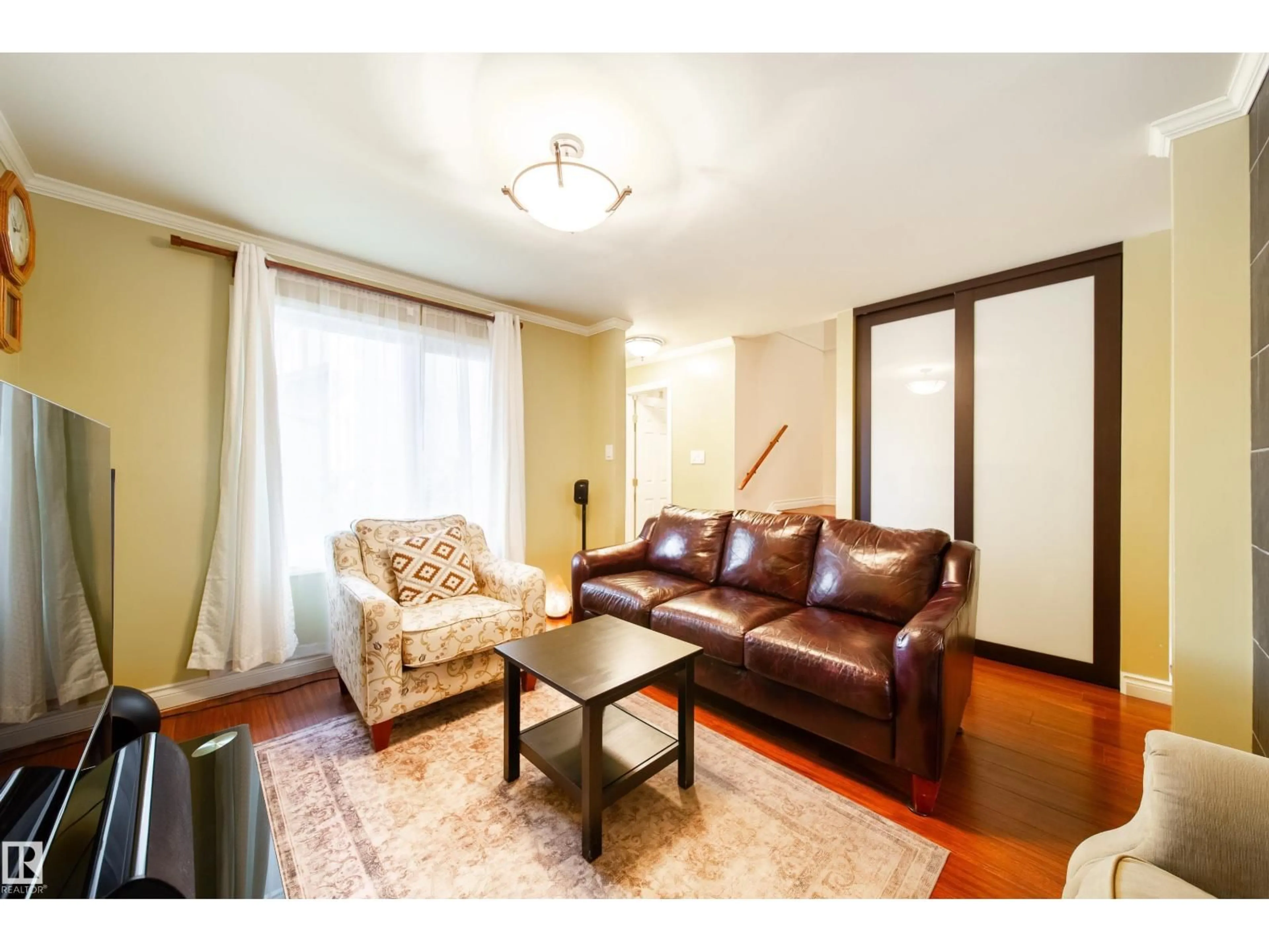 Living room with furniture, wood/laminate floor for 5 11111 26 AV NW, Edmonton Alberta T6J5M7