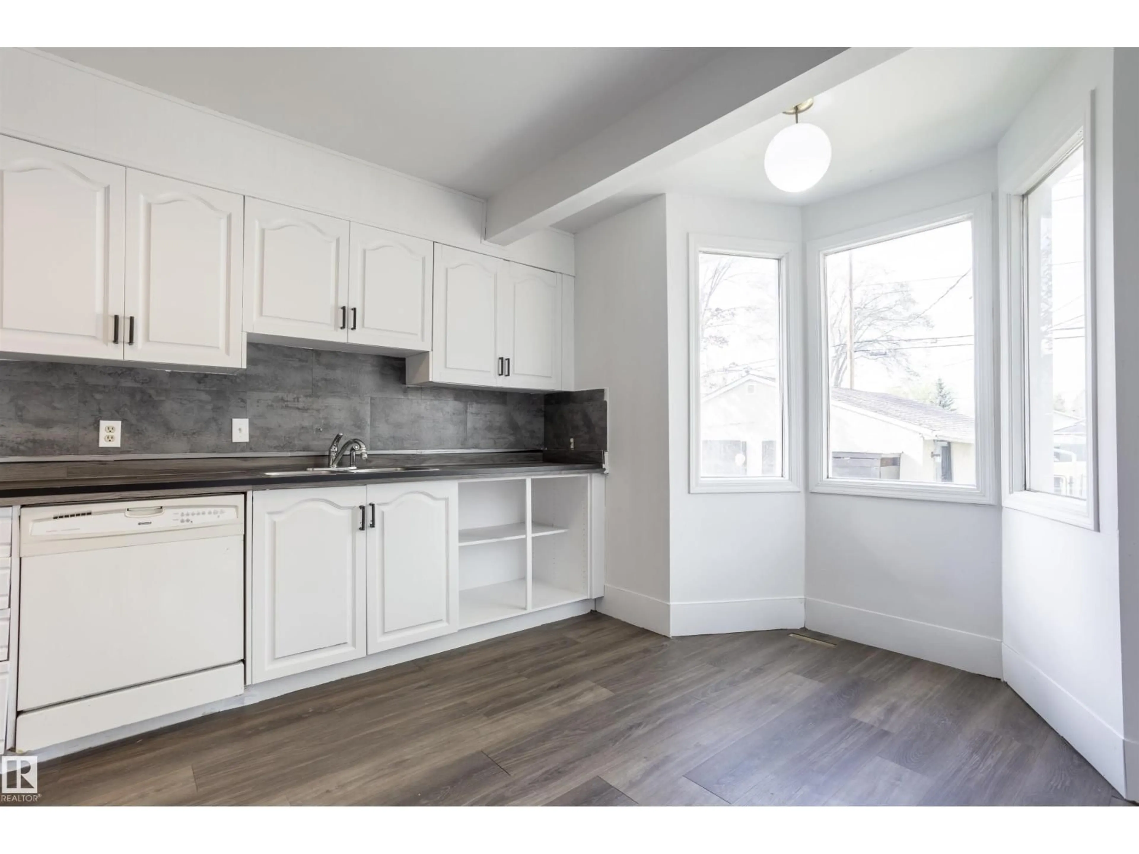 Open concept kitchen, wood/laminate floor for 13716 115 AV, Edmonton Alberta T5M3B3
